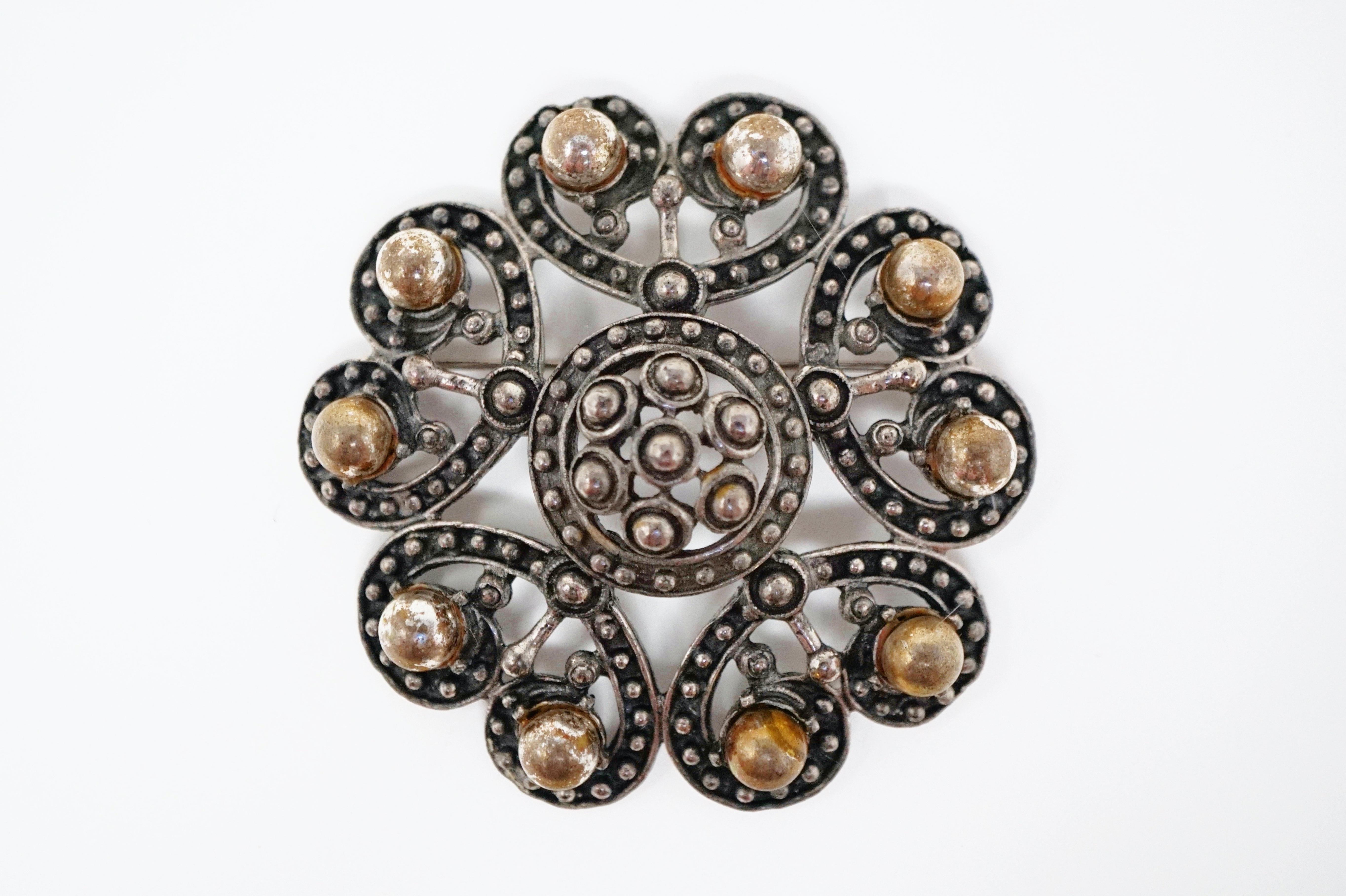 This rare silver tone brooch by Florenza, circa 1960, is an ornate piece inspired by the Victorian era.  The rich gunmetal tone and heft of this piece make it a very unique piece of vintage costume jewelry from the coveted brand Florenza. A