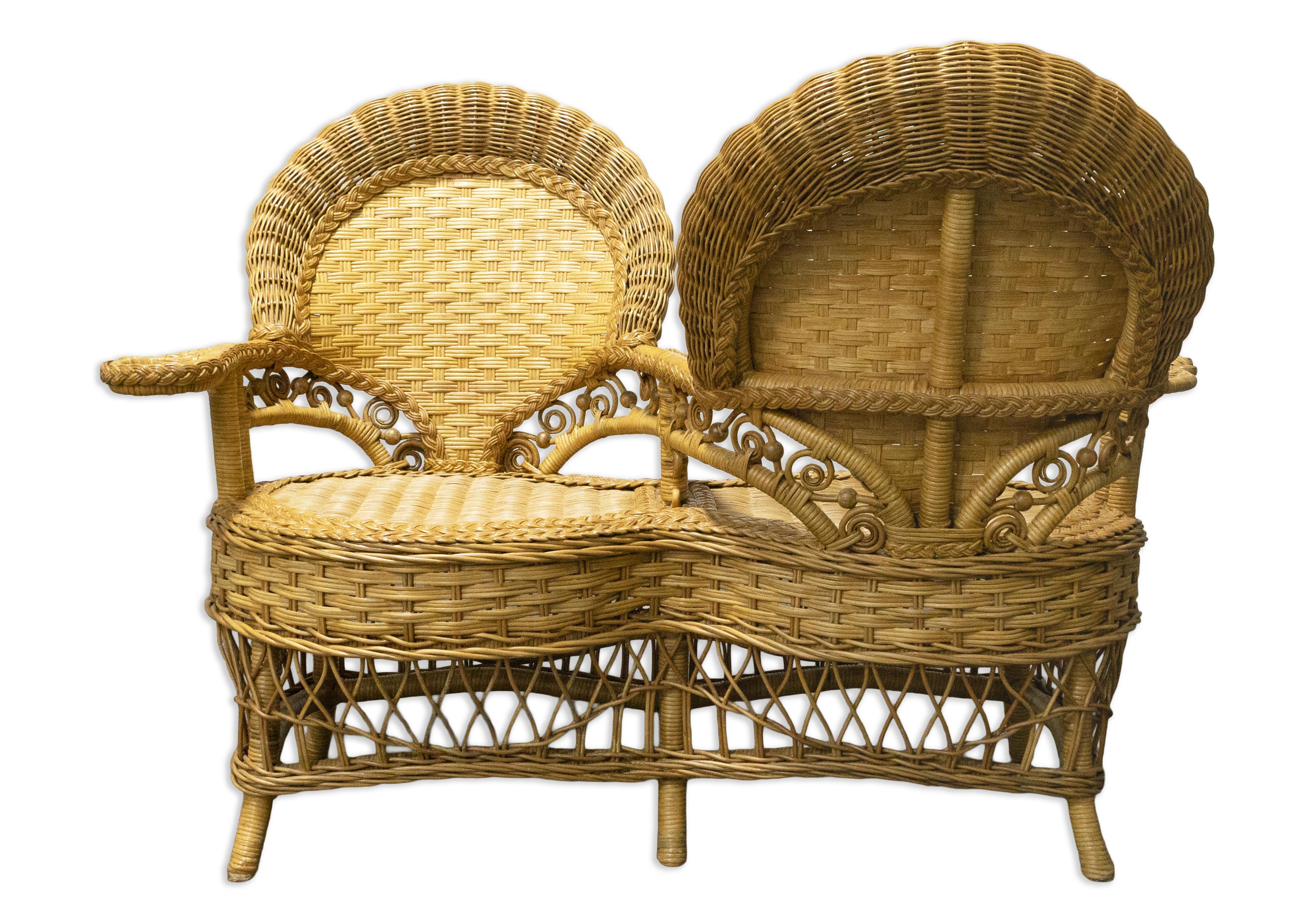 Rattan 2-Person Patio Gossip Bench. This rattan bench is perfect for outdoor seating and can also be used indoors. It comfortably accommodates two people in a unique gossip style, allowing you to face the person you are sharing it with. The rattan