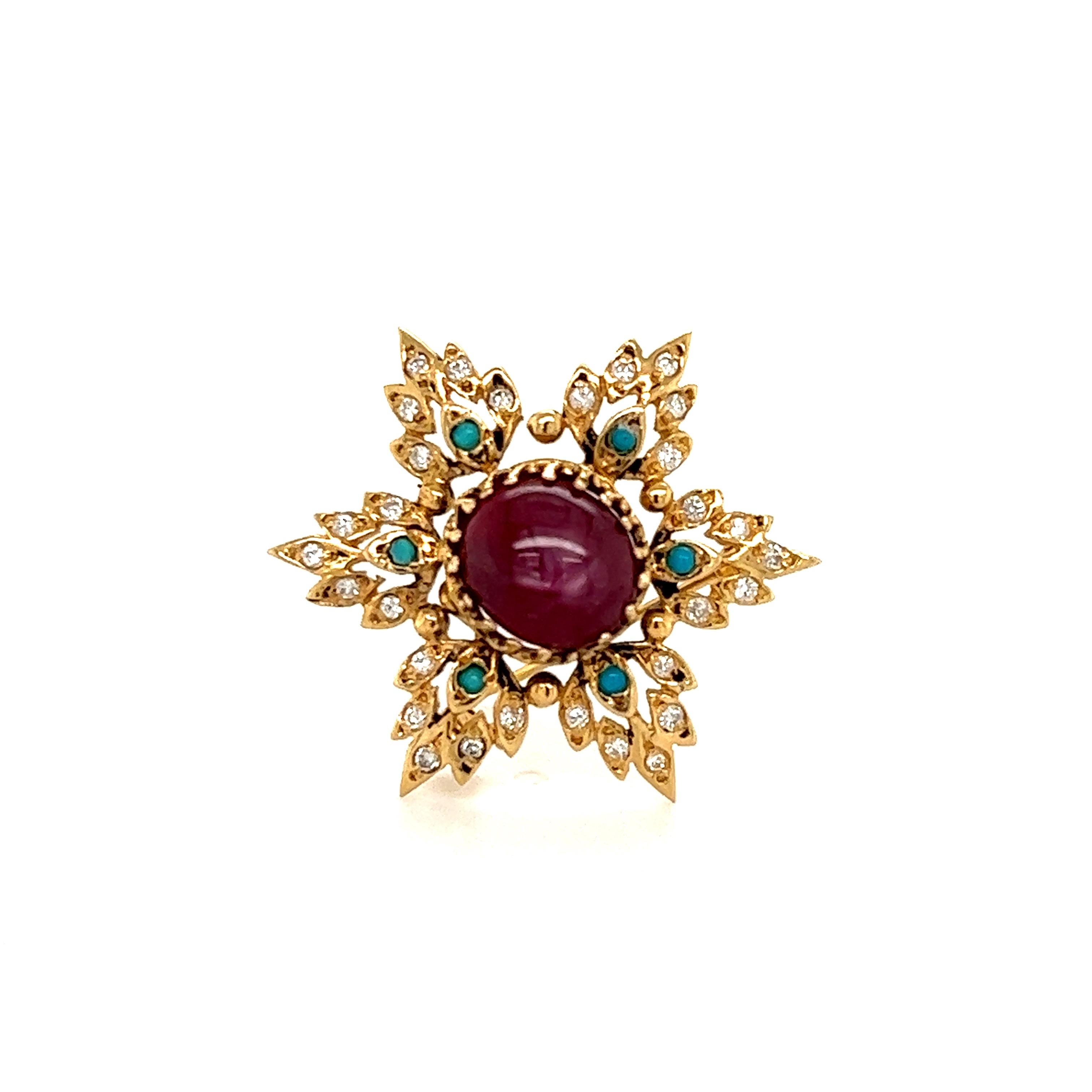 Beautiful snowflake brooch crafted in 14k yellow gold. The brooch highlights one star ruby gemstone showing a deep red color and natural growth patterns with electric asterism. Ornate detail is seen throughout as turquoise gemstones accent the