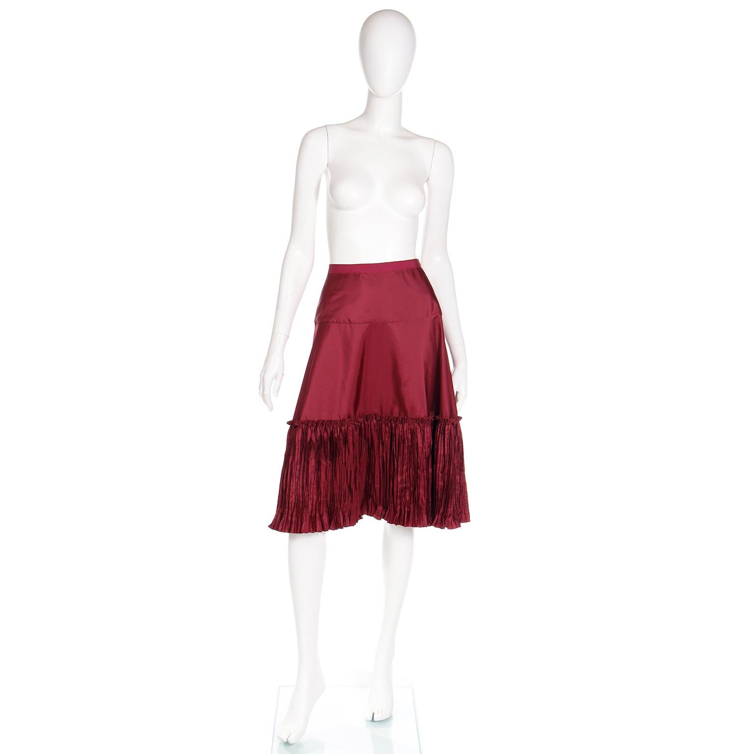 We are huge Oscar de la Renta fans and this fun vintage skirt is a perfect piece to add to any holiday wardrobe! This high waisted skirt is in a luxurious burgundy taffeta and it has a unique bottom tier that is vertically pleated in a Fortuny