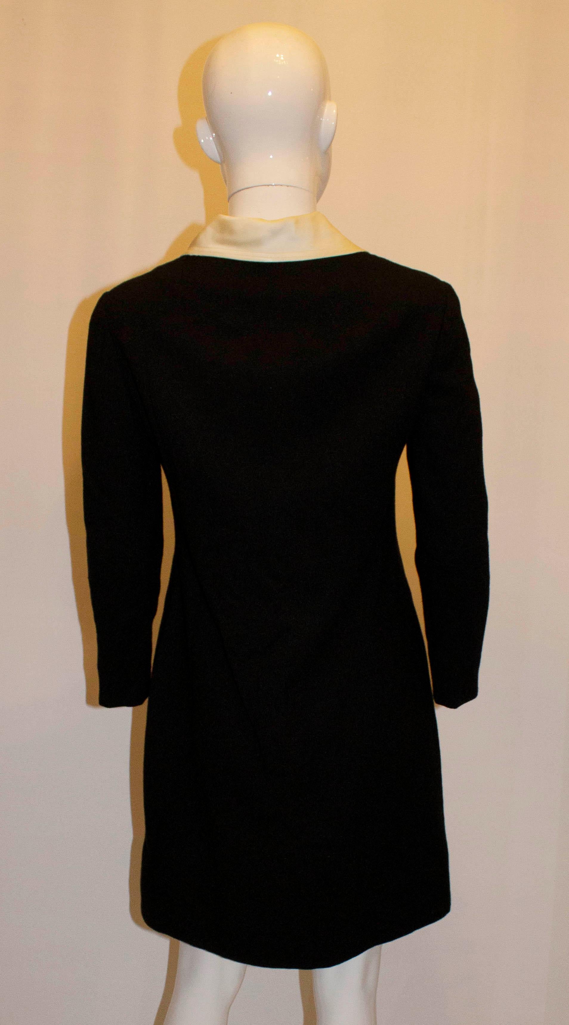 A chic and head turning dress by Oscar de la Renta with a wonderful diamante zip. The dress is in a black wool crepe with white satin collar and front pockets.  The dress is fully lined.
Measurements: Bust up tto 36'',length 35''