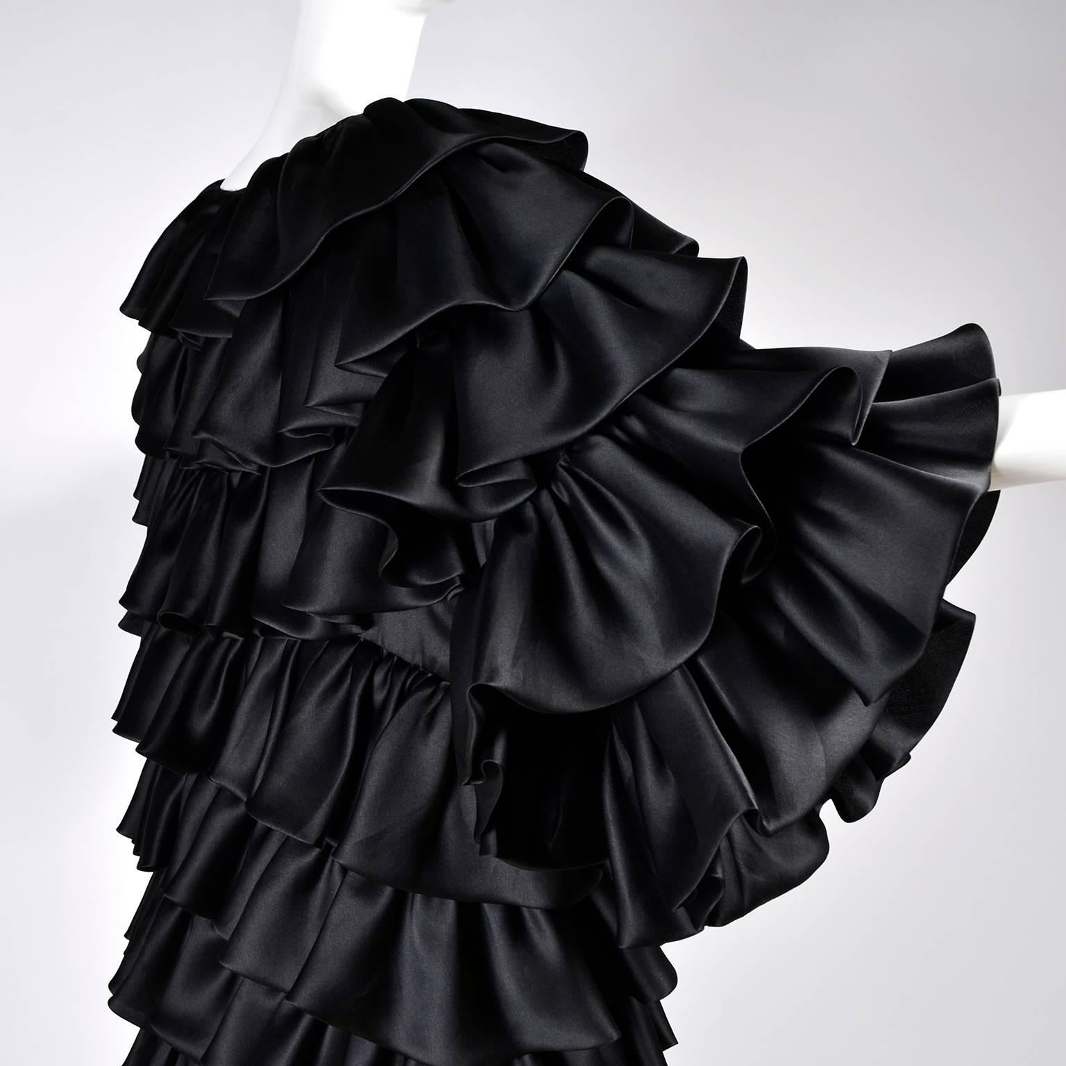 This ruffled black vintage Oscar de la Renta coat was purchased at Lord & Taylor and made in the USA in the early 1990s. This gorgeous evening coat has tiers of black ruffles and is lined in fine organza.  It's hard to photograph the way the