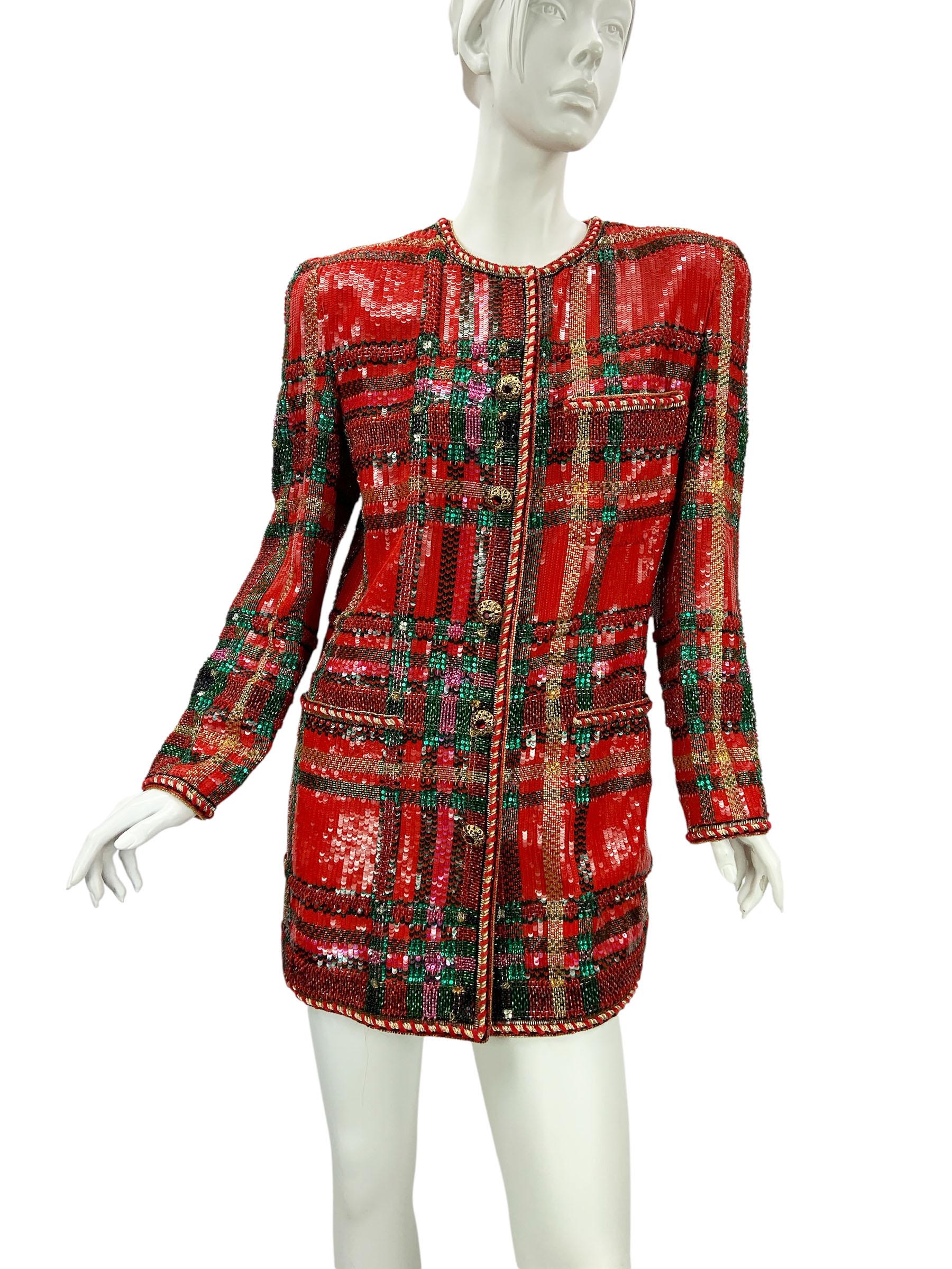 A striking statement piece from Oscar de la Renta’s Fall/Winter 1991 runway collection. This long jacket is masterfully crafted in a bold tartan-inspired pattern, entirely hand-embroidered with sequins and glass beads in vibrant red, green, gold,