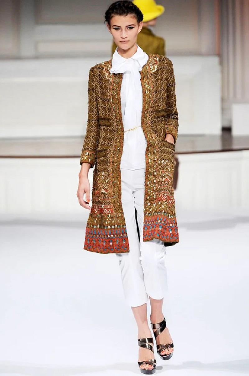 Oscar de la Renta Fully Embellished Coat with Matching Skirt
S/S 2010 Runway Collection
US size - 6
Exquisitely embellished with gold tone sequins, colorful embroidery and attached net over the coat.
Coat finished with two deep packets, two