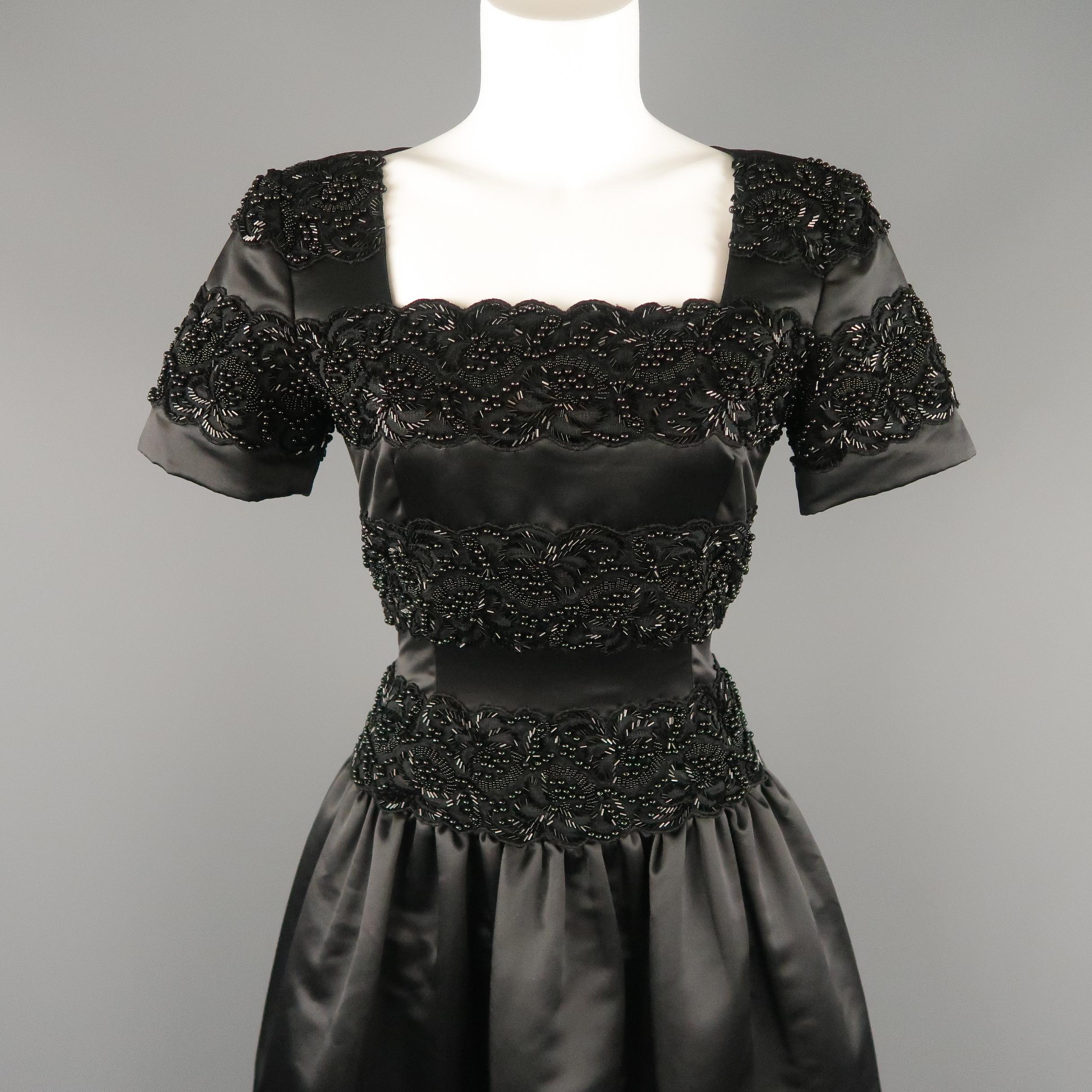 Vintage OSCAR DE LA RENTA STUDIO evening gown comes in black satin with a portrait collar, short sleeve, beaded top and drop waist gathered , full length, A line skirt.
 
New with Tags .
Marked: 4
 
Measurements:
 
Shoulder: 14 in.
Bust: 36