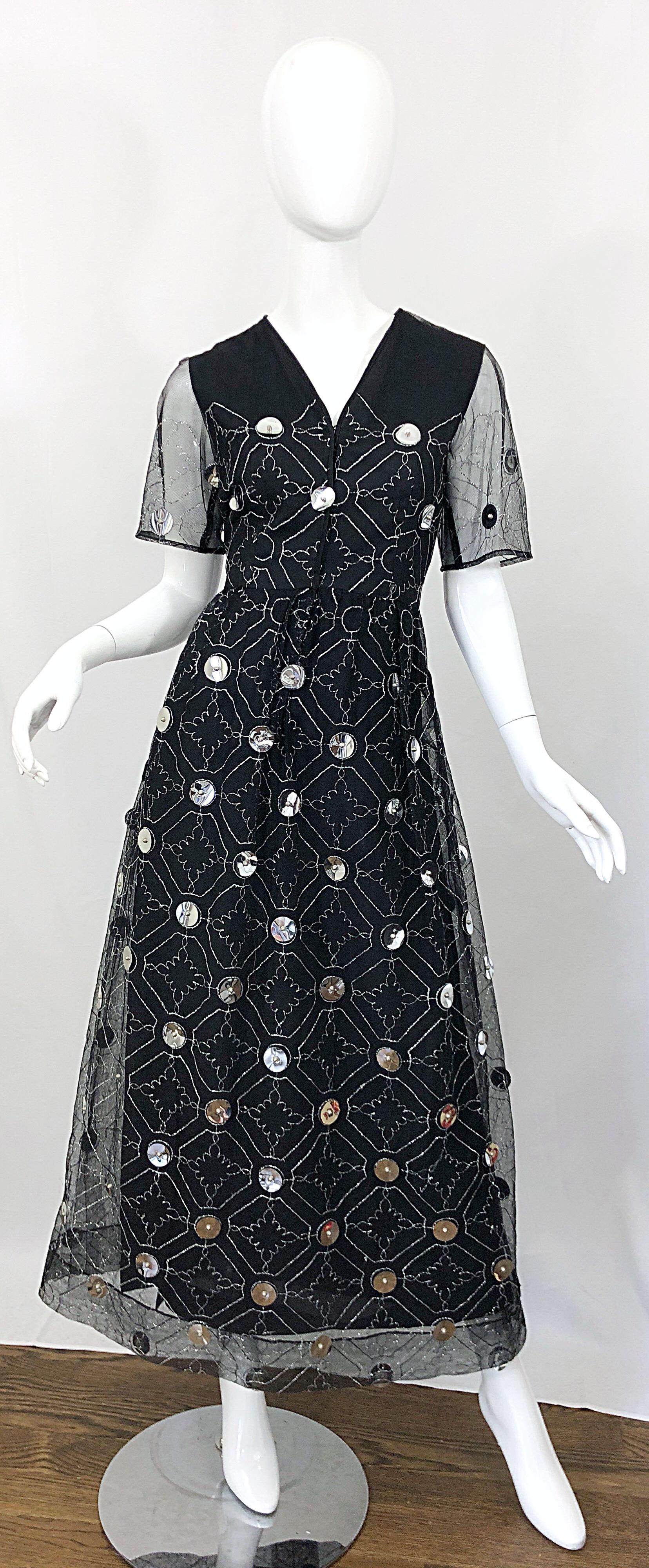Wonderful early 1970s OSCAR DE LA RENTA black silk and tulle + silver pailletes short sleeve evening gown! Features a sleeveless silk base with black tulle short sleeve attached overlay. Metallic silk embroidery throughout. Hundreds of large