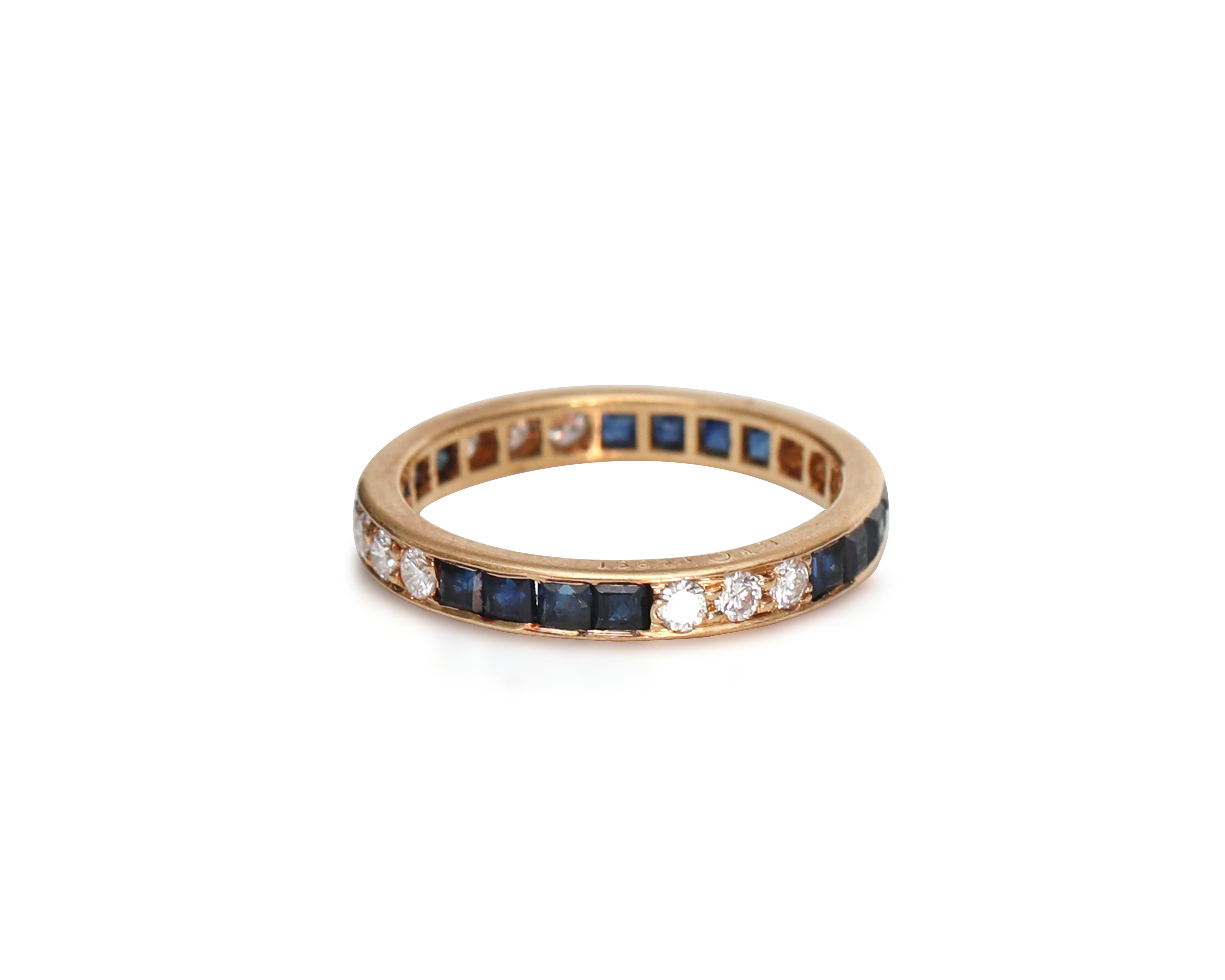 This piece is a genuine 1950s era Orcar Heyman Art Deco style eternity band featuring a stylish pattern of alternating sections of diamond and blue sapphires set crafted of 18 karat gold! There is a pierced open back pattern throughout the ring to