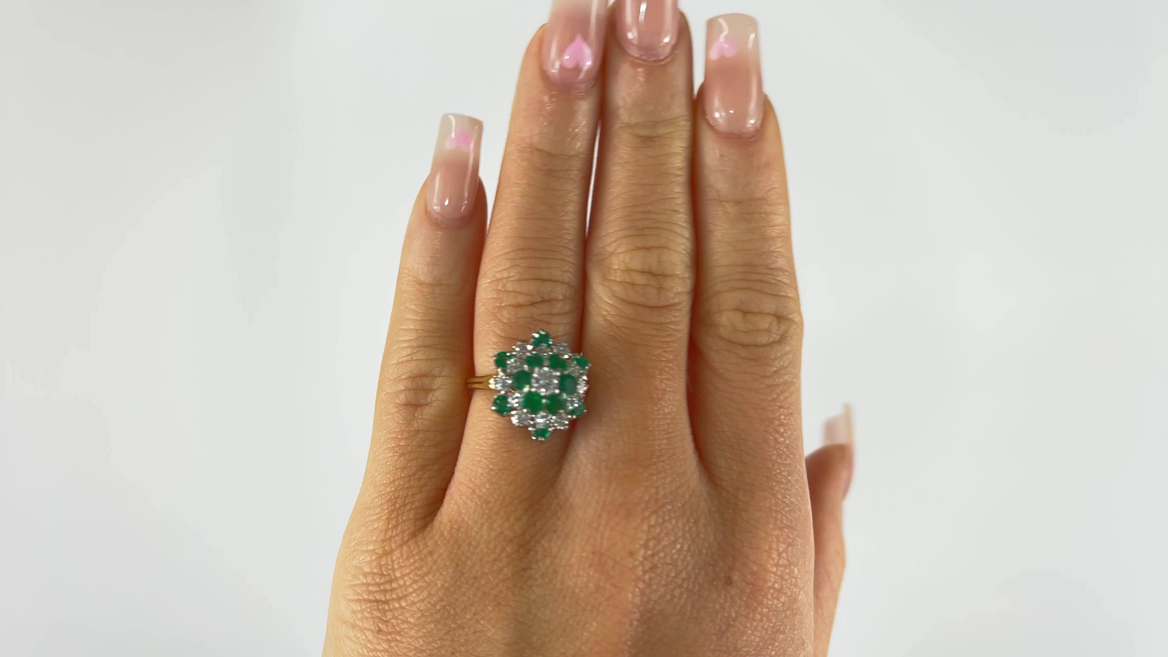 One Vintage Oscar Heyman Emerald Diamond 18 Karat Gold Cluster Ring. Featuring 13 round brilliant cut diamonds with a total weight of approximately 1.10 carats, graded D-E color, VS clarity. Accented by 12 round emeralds with a total weight of