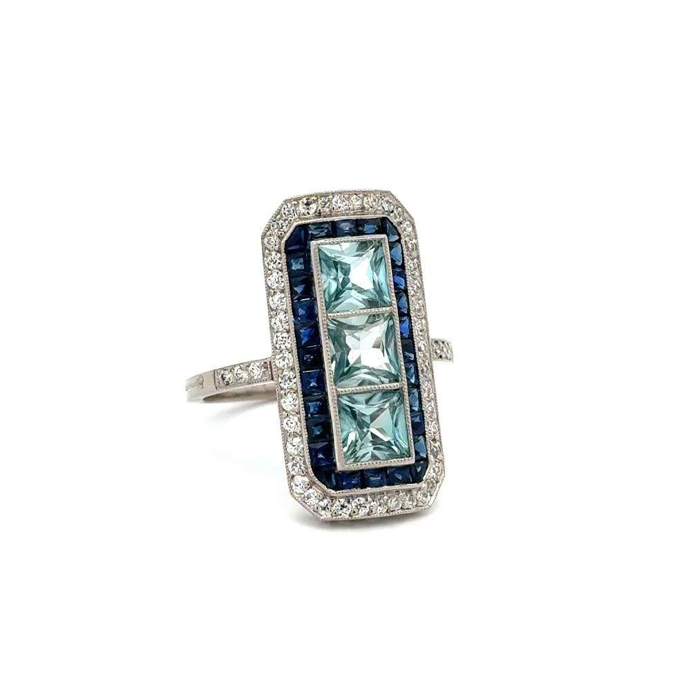 Simply Beautiful! Elegant and finely detailed Blue Zircon Sapphire and Diamond Vintage Rectangular Platinum Statement Cocktail Ring. Centering 3 securely nestled Hand set Square Blue Zircon Gemstones, weighing approx. 2.57tcw, surrounded by
