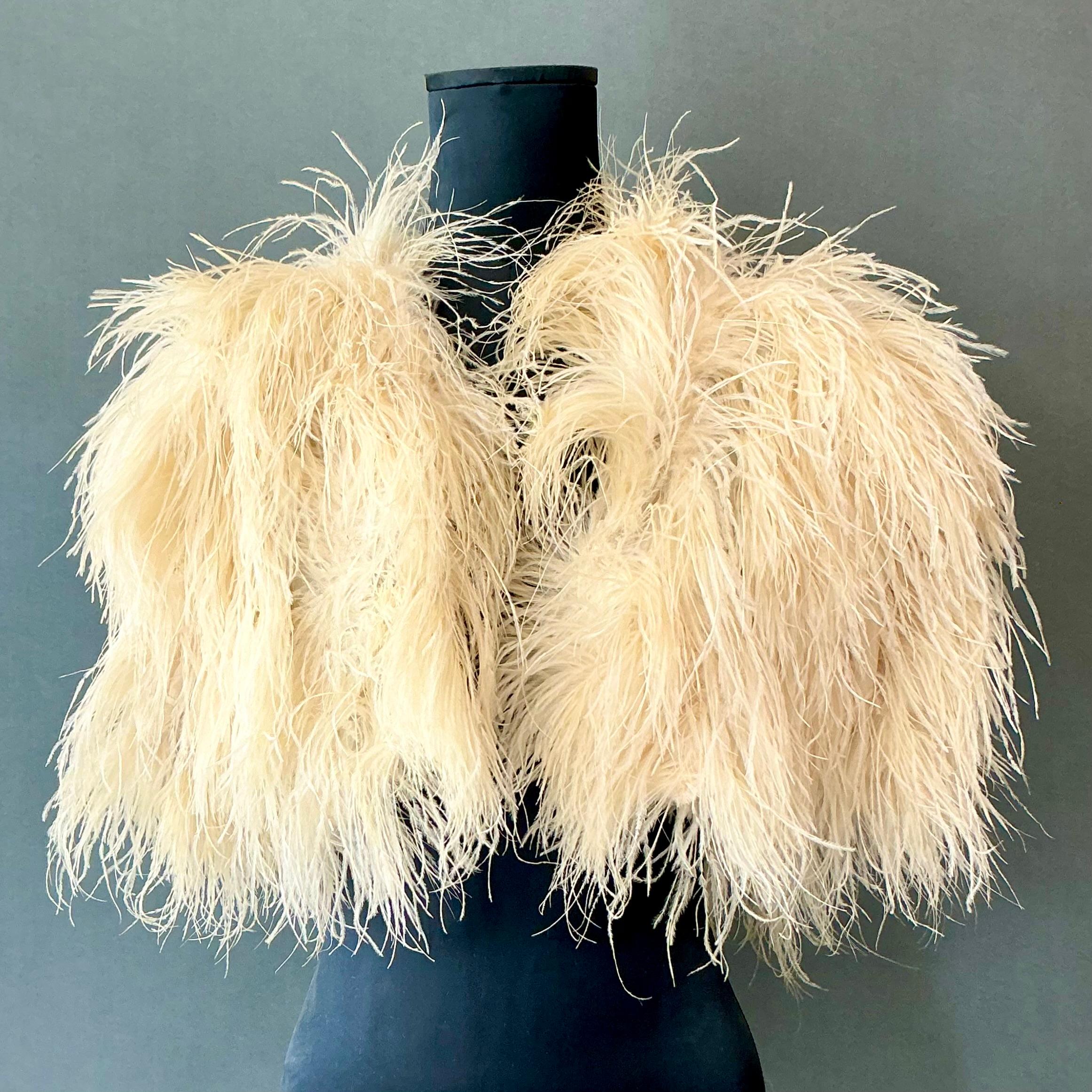 A Vintage Ostrich Feather Peignor is an opulent and romantic piece of vintage lingerie or loungewear, often associated with Old Hollywood glamour and luxurious leisurewear. 