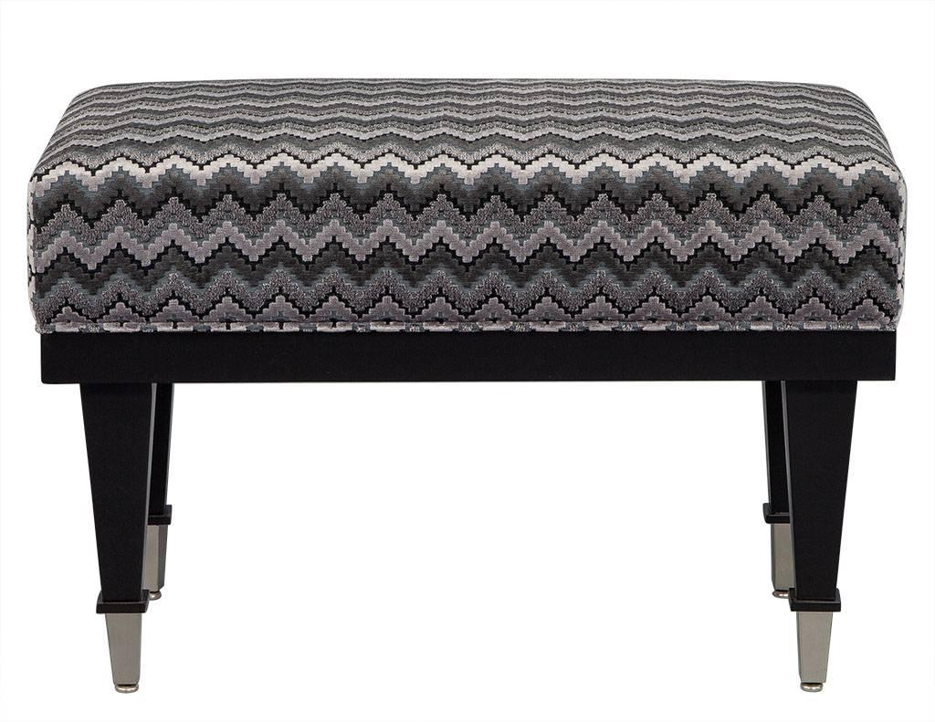 Vintage ottoman with designer upholstery, this compact bench is perfect to accommodate small living spaces. New, stitched, designer upholstery and dark lacquered wooden legs provide a simple yet luxe look with the nickel capped feet. The Classic