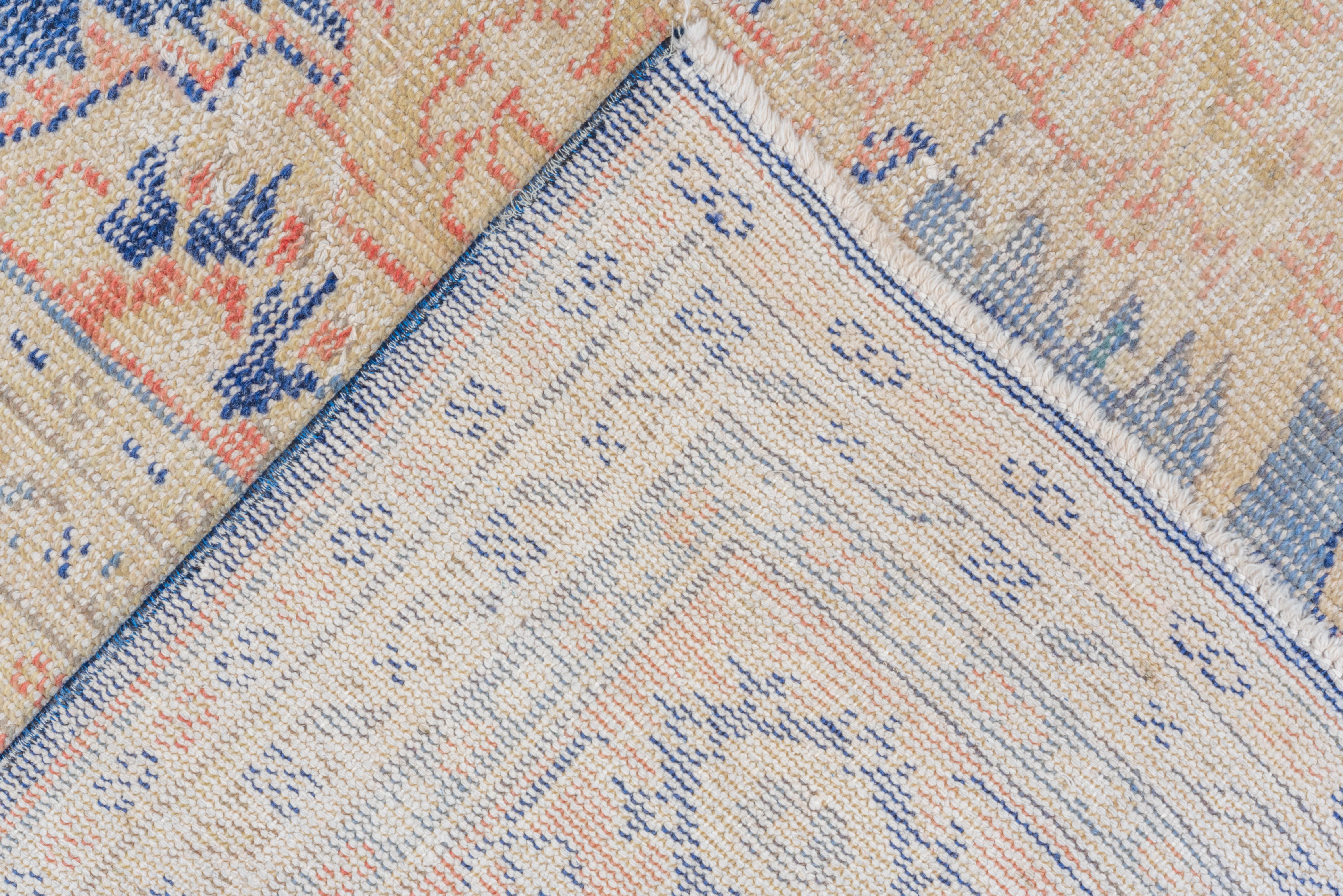 This beautiful Oushak carpet stands the test of time for its long-lasting beauty and quality. The colors on this pre-loved antique remain vibrant, still. This carpet is a one-of-a-kind piece made over a century ago in Turkey and is patiently
