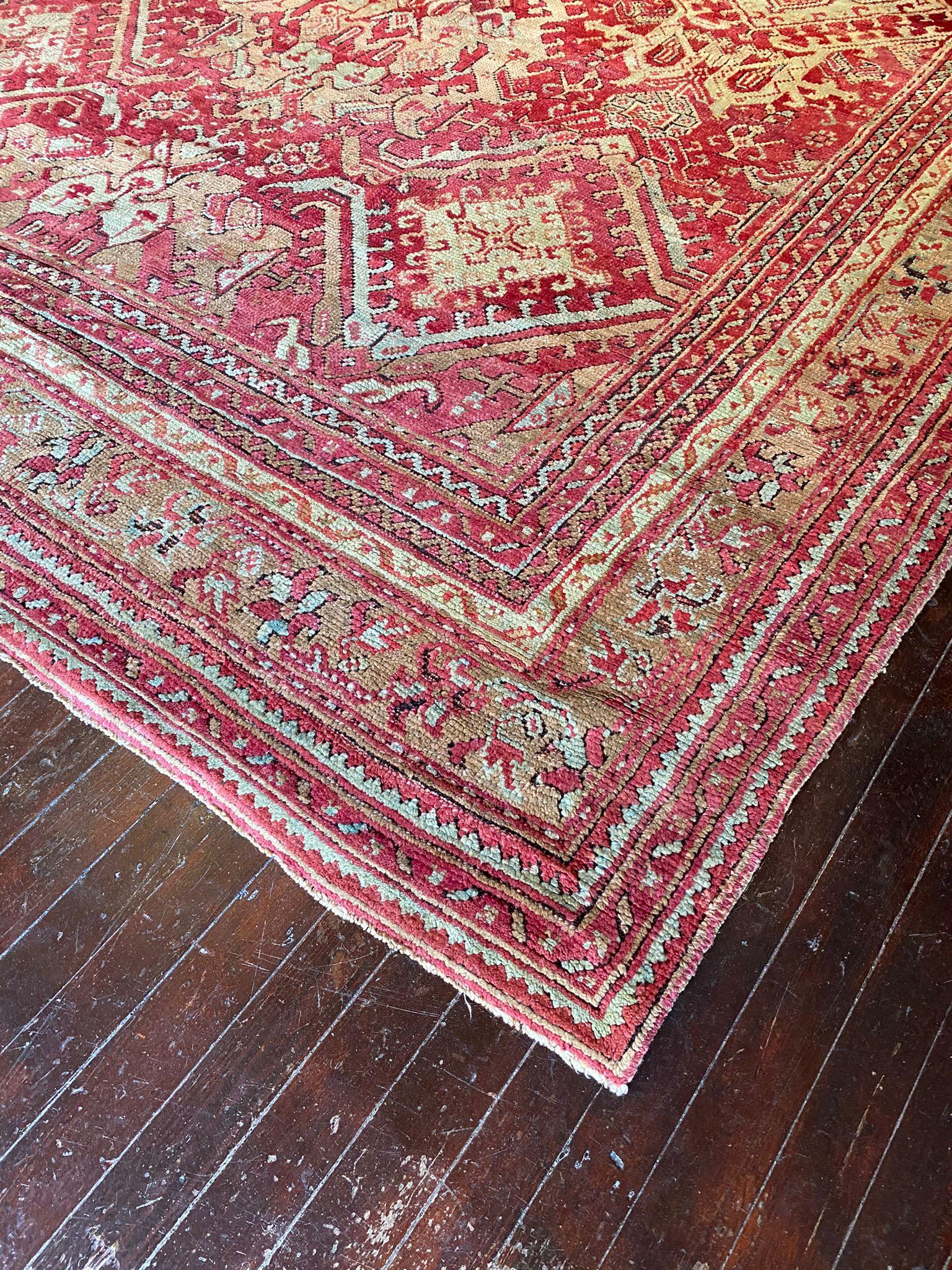 




The Vintage Oushak Rug is an exquisite masterpiece that effortlessly captures the essence of timeless beauty and sophistication. Its allure lies in the rich and deep reds that form the foundation of its color palette, exuding a sense of