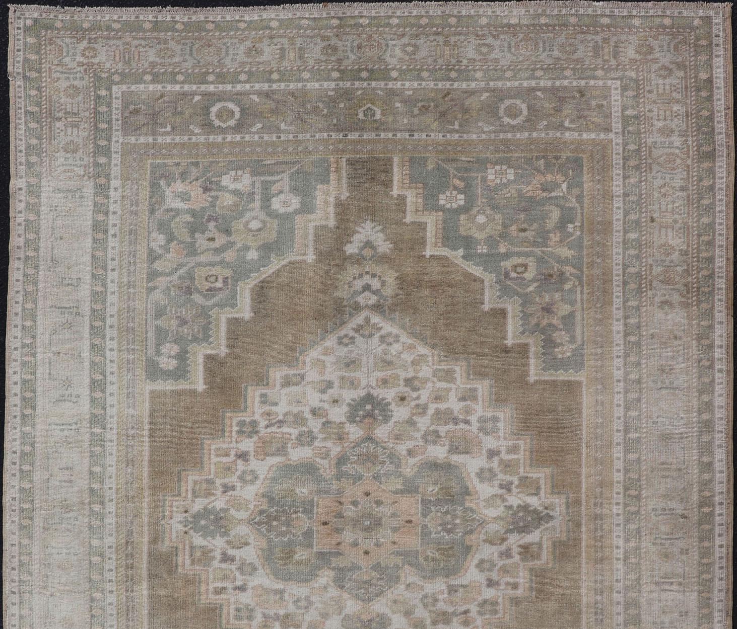 Turkish Vintage Oushak Rug from Turkey with Muted Colors and Floral Medallion For Sale