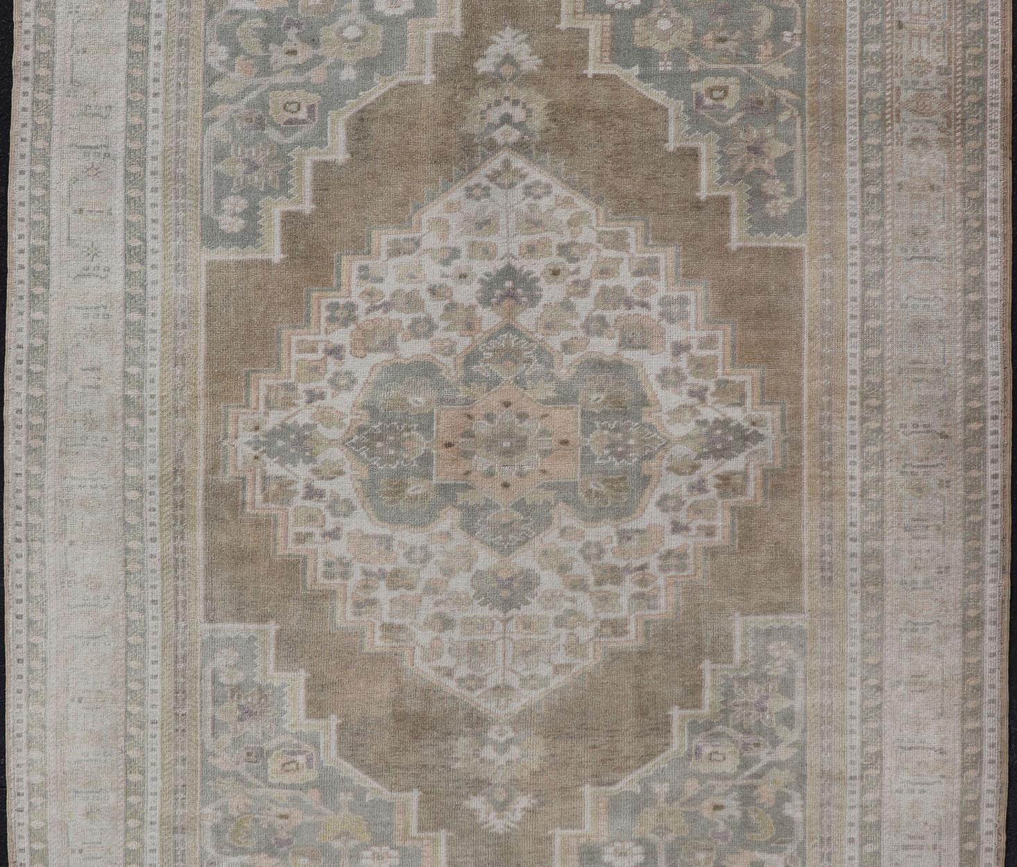Hand-Knotted Vintage Oushak Rug from Turkey with Muted Colors and Floral Medallion For Sale