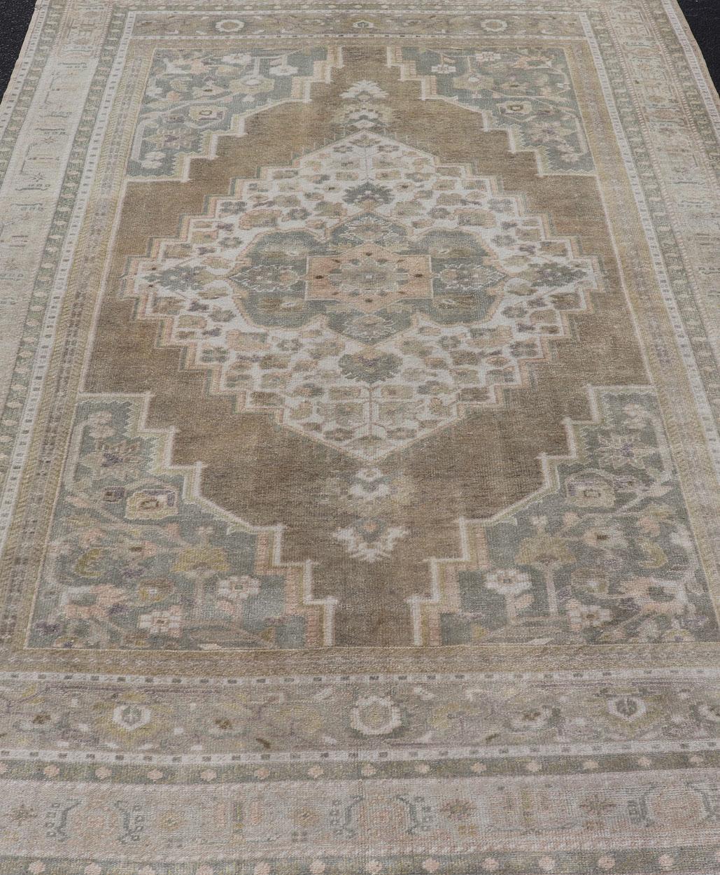 20th Century Vintage Oushak Rug from Turkey with Muted Colors and Floral Medallion For Sale
