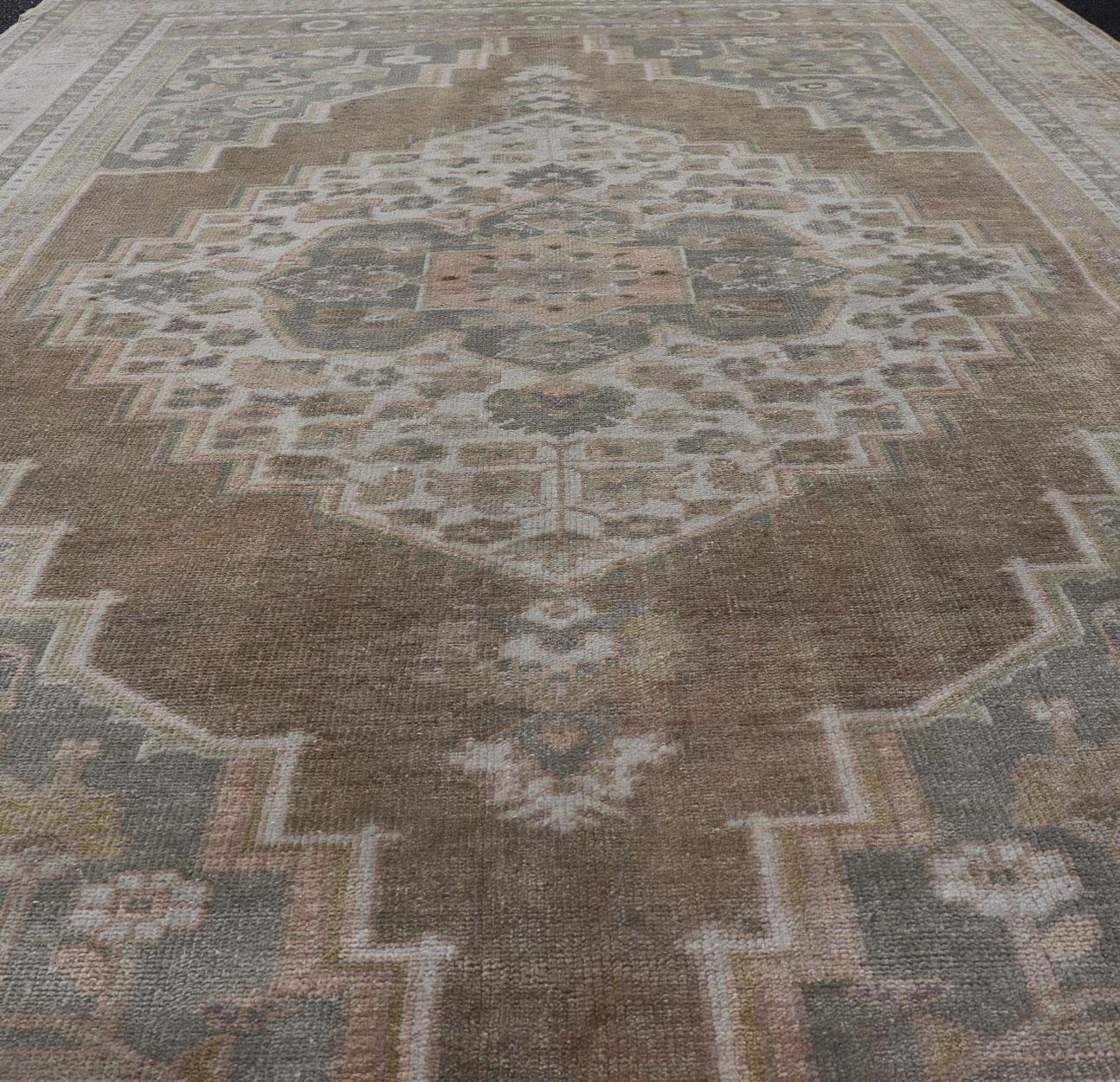 Wool Vintage Oushak Rug from Turkey with Muted Colors and Floral Medallion For Sale