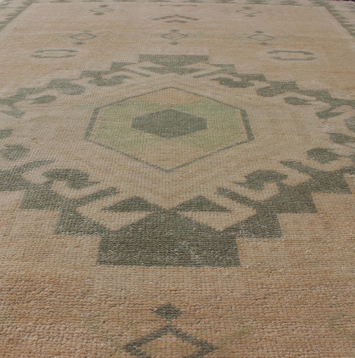 Wool Vintage Oushak Rug with Central Medallion Warm Tones And Green Tones For Sale