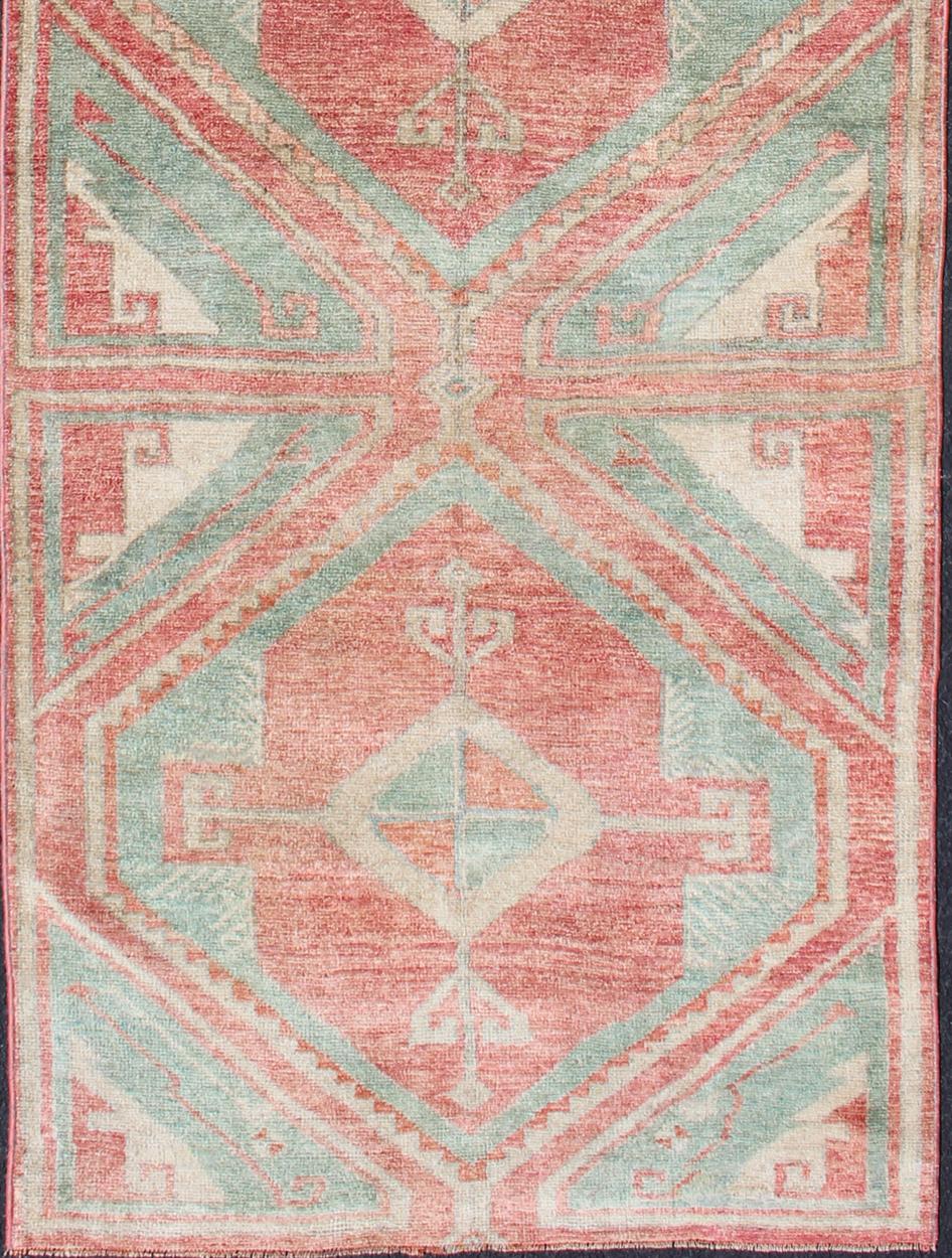 Two-toned Turkish runner with Diamond design, rug en-165990, country of origin / type: Turkey / Oushak, circa 1940.

This colorful Oushak runner consists of three diamond shapes expanding across the central field and rendered in colors such as