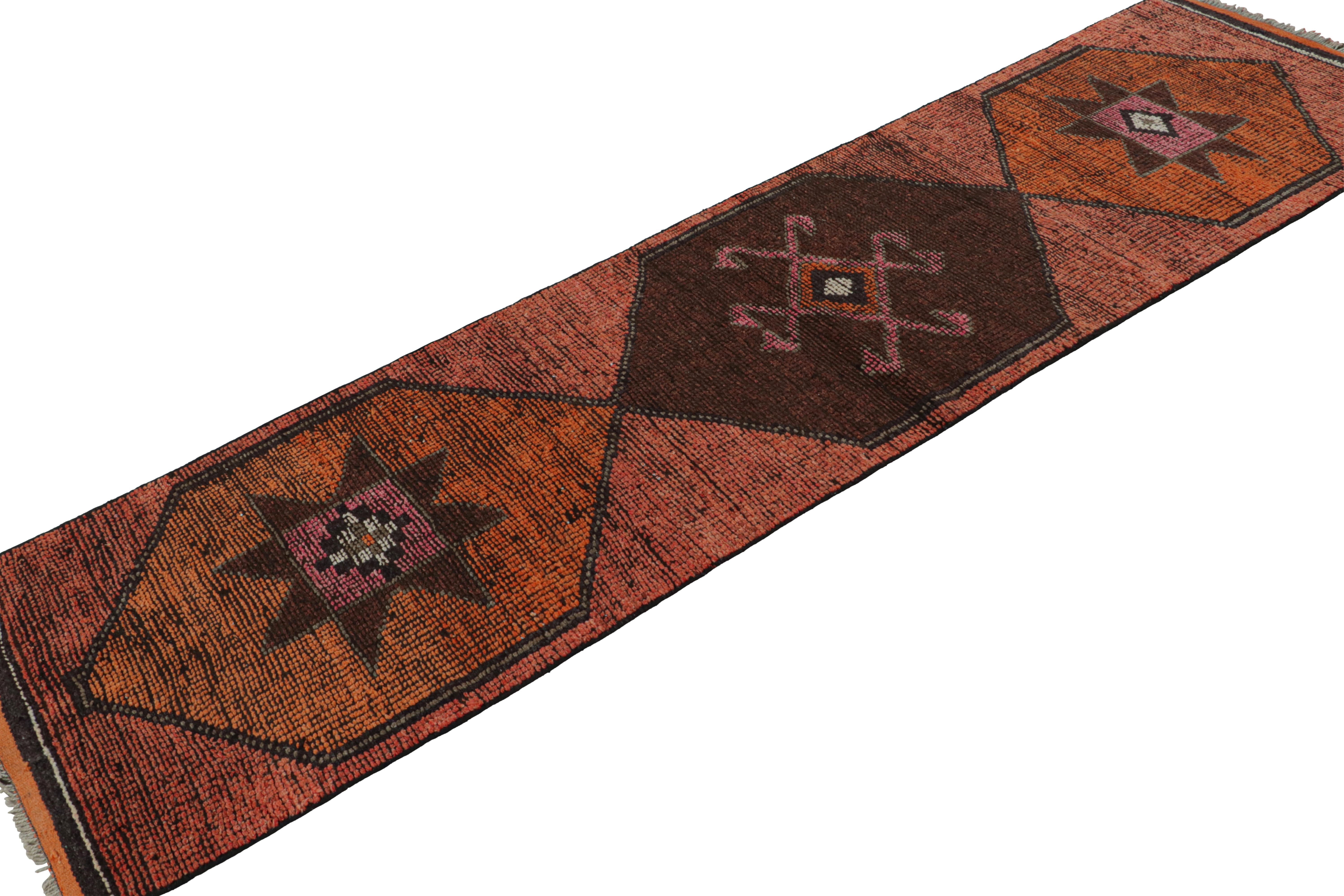 Hand Knotted in wool, this vintage 3x10 Oushak runner rug from the rare series of mid-century runners, features medallions and geometric patterns in warm and bright accents such as pink, orange and rust tones. 

On the Design: 

Connoisseurs will