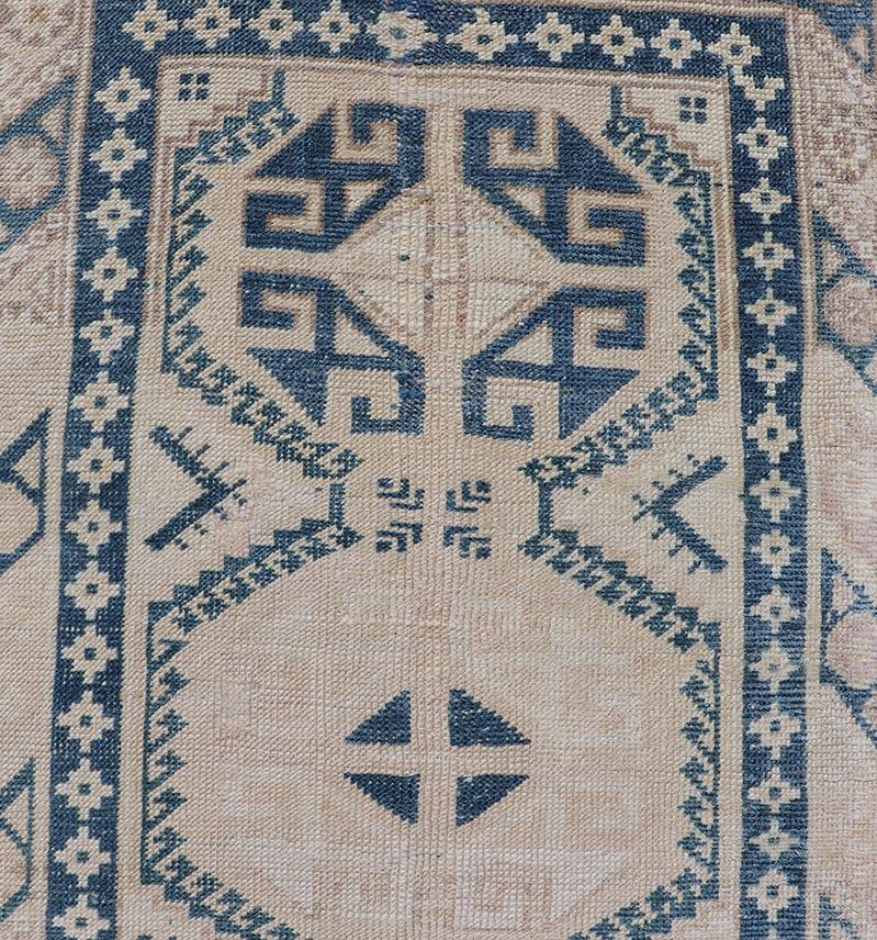 Vintage Oushak Turkish Runner with Geometric Design in Blue, Tan, and Blush. Rug EN-15277 country of origin / type: Turkey / Oushak, circa 1940

Measures: 2'5 x 9'8 

This vintage Turkish runner from Turkey features an arrangement of geometric