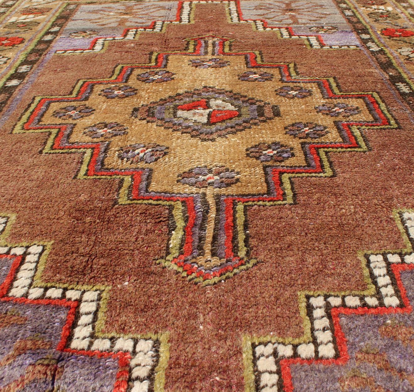 Colorful vintage Turkish oushak with Geometric design.

Vintage Turkish rug in green, soft yellow, pale purple, ivory, red, tan & taupe, keivan woven arts / rug EN-176061, country of origin / type: Turkey / oushak, circa 1940.

Measures: 3'2 x