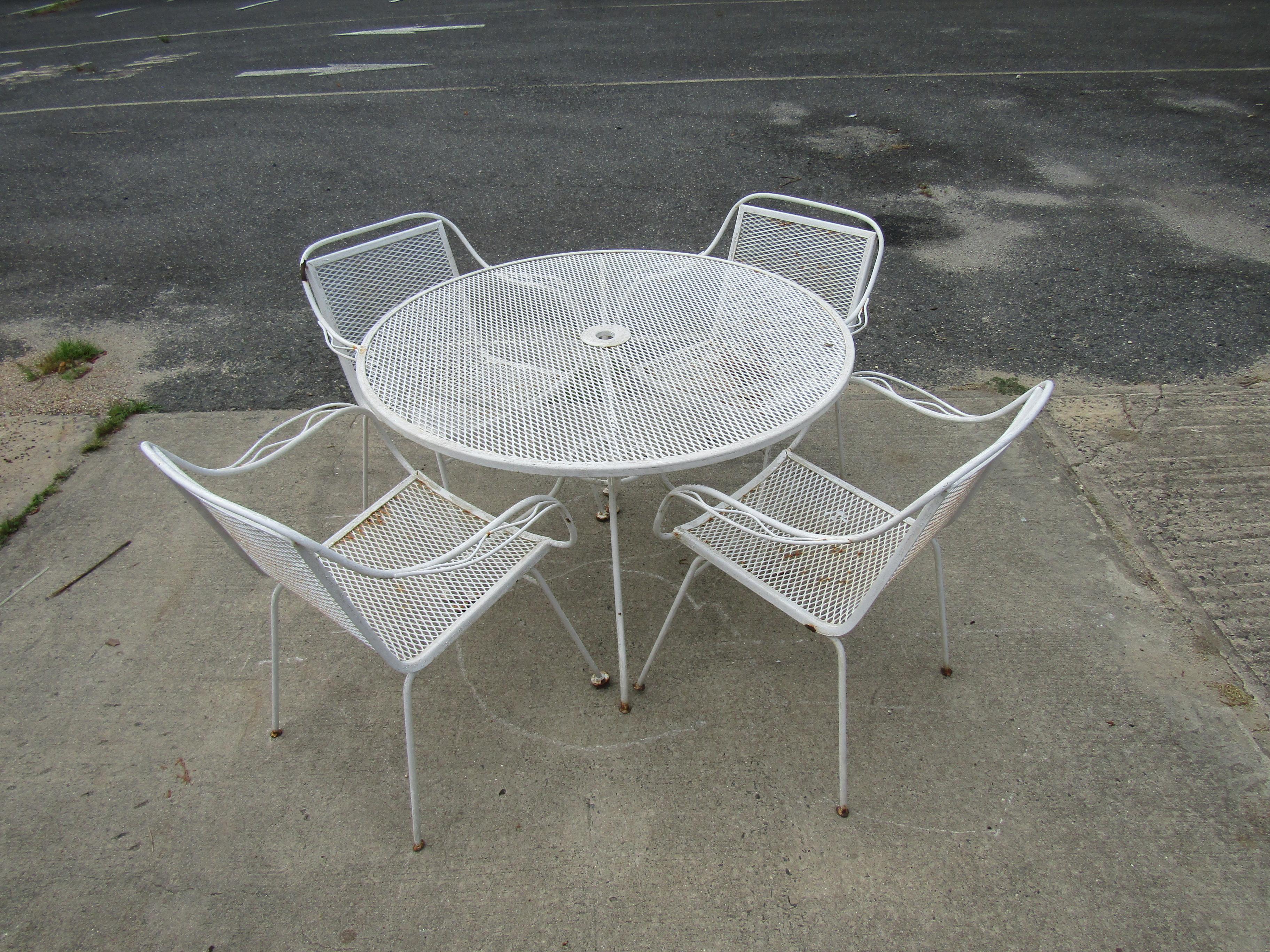 This vintage outdoor patio set, featuring four armchairs and a round table, all in painted metal material. Please confirm item location with seller (NY/NJ).

Dimensions:
Table- Diameter: 41