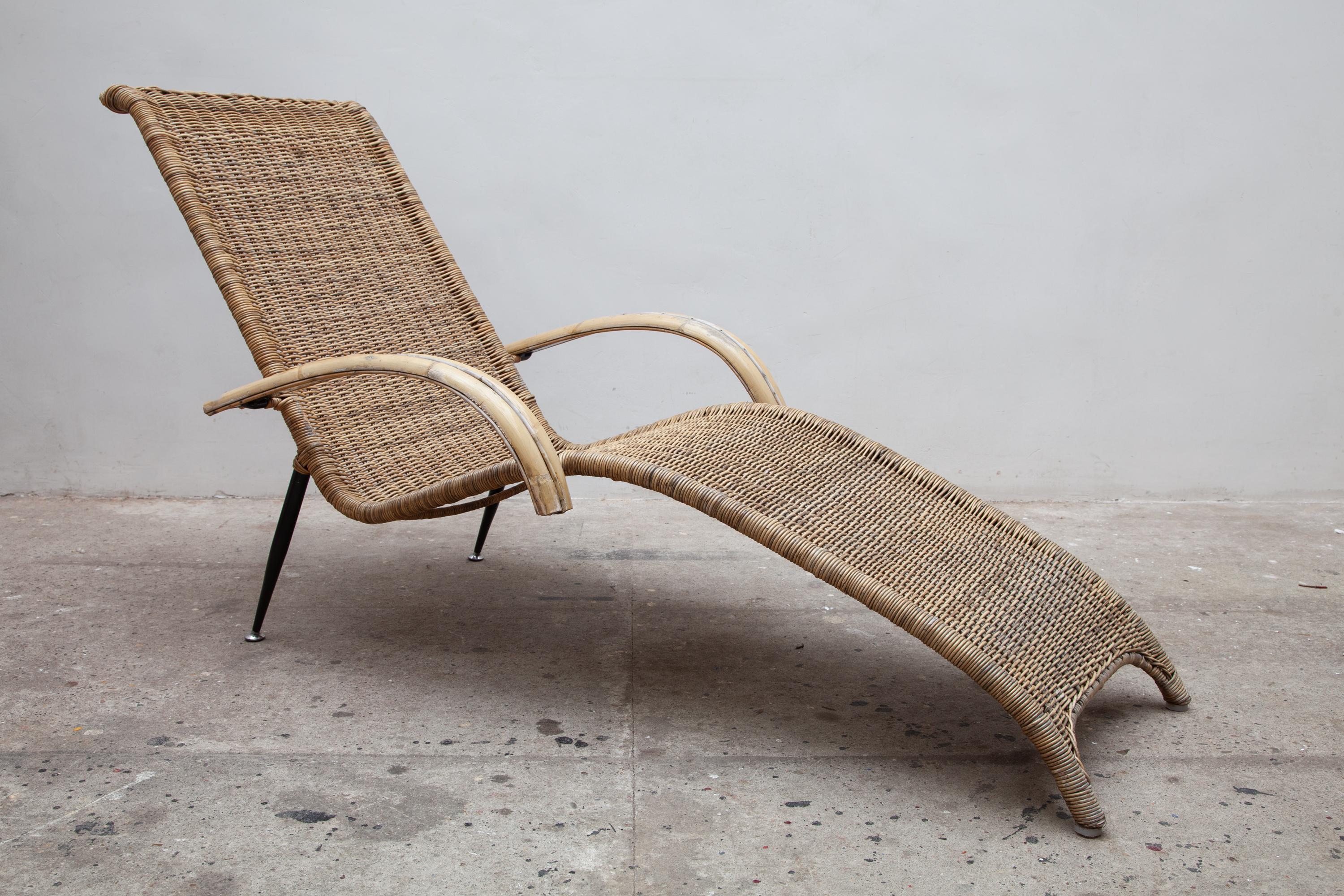 Rattan garden mid century lounge chairs. Woven wicker with bamboo armrests and metal legs. Sturdy metal frame.

Dimensions: 170 W x 70 D x 86 H cm.