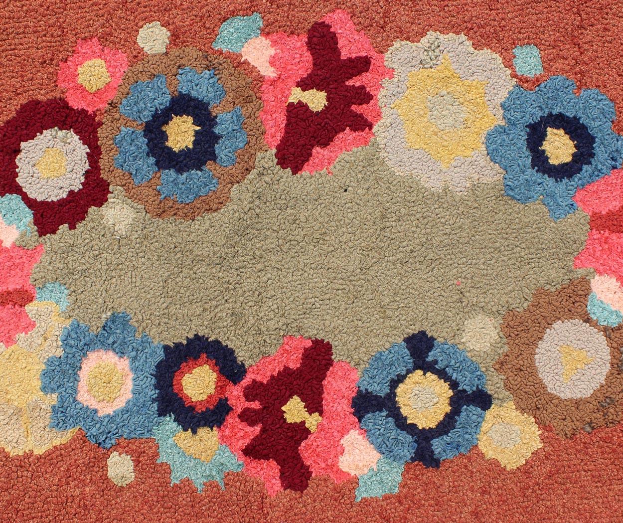 Oval shape American Hooked rug with large flower design, rug S12-1206, country of origin / type: United States / Hooked, circa 1950

This colorful American Hooked rug depicts a variety of vines and blossoming flowers in an assortment of colors