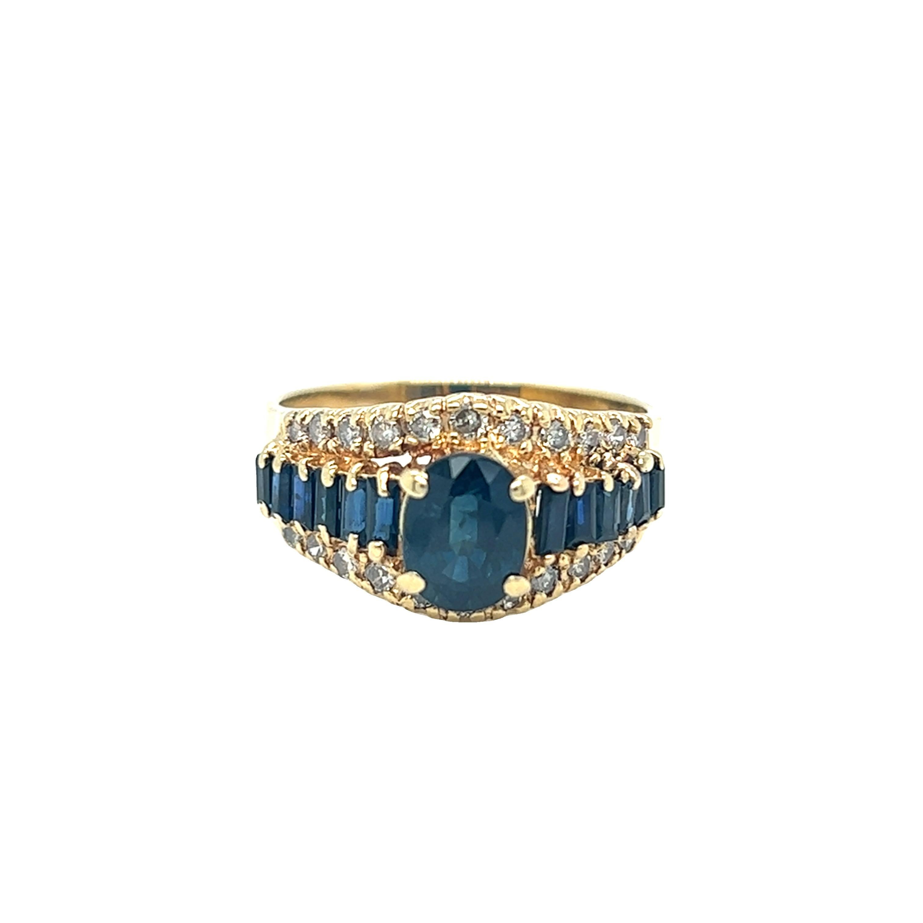 Vintage sapphire ring features oval shaped sapphire with baguette sapphire graduation down the band to accentuate the center stone. Small round brilliant cut diamonds on either side of the sapphire create a beautiful contrast. The ring was crafted