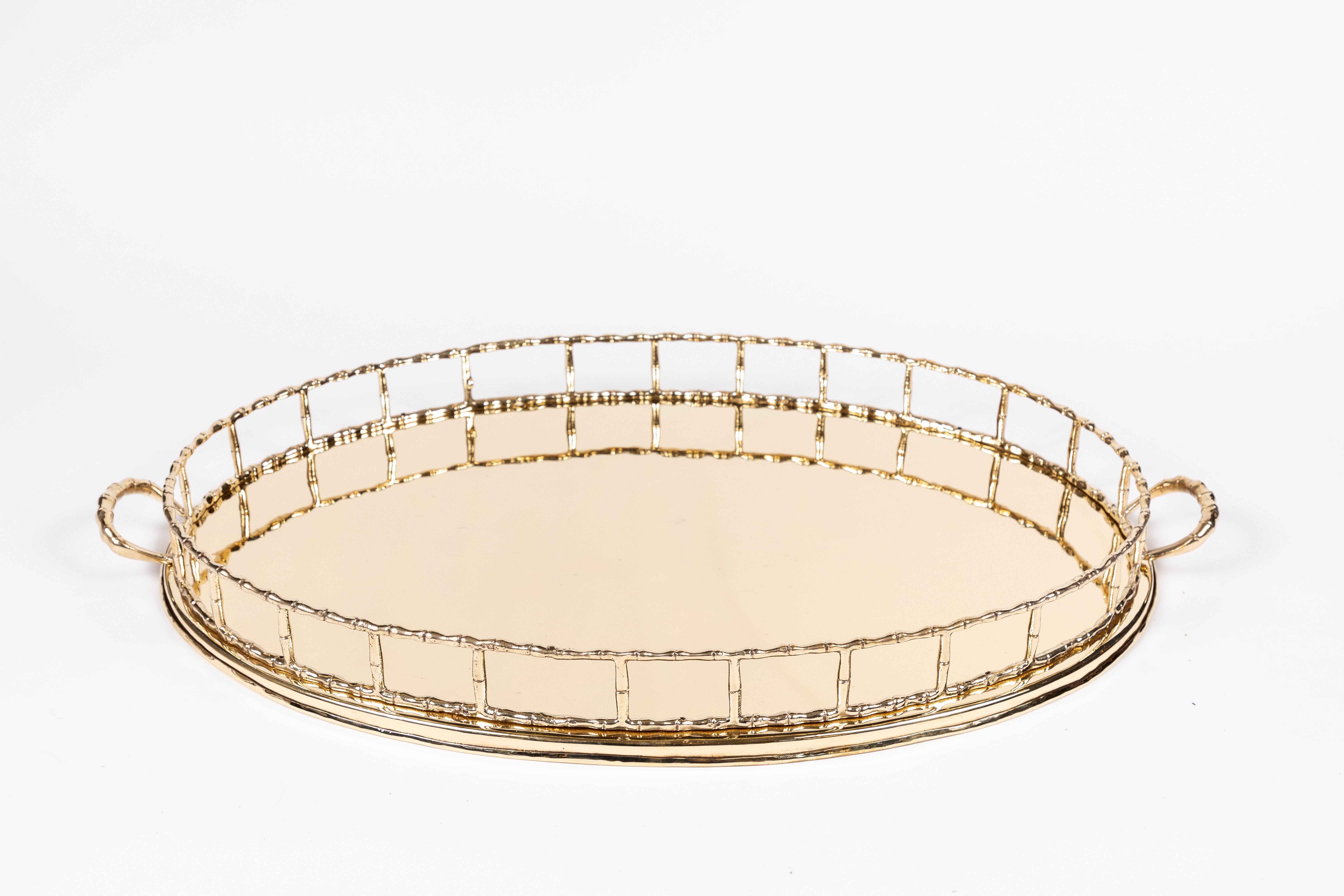 Oversized vintage oval brass tray with 'Bamboo' gallery rail and matching 'Bamboo' handles. This piece has been newly polished and is ready for display or service. Measures: 27