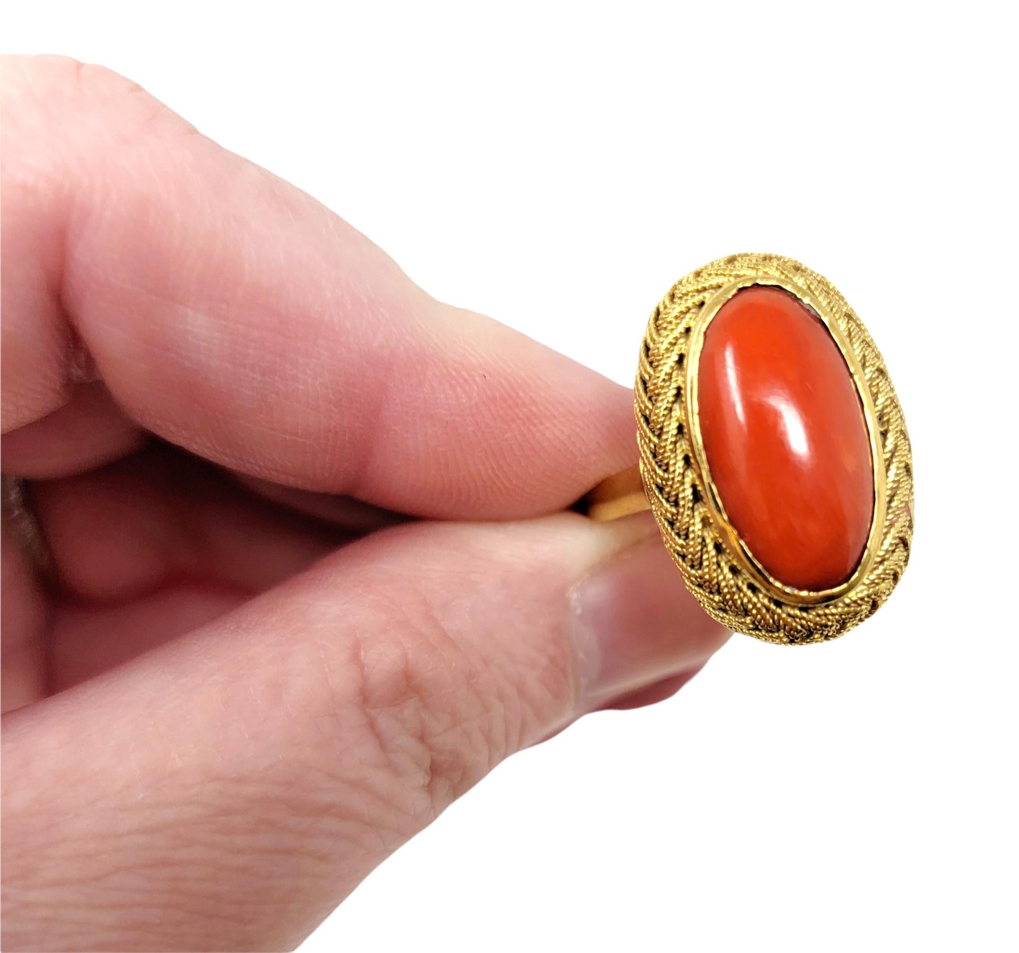Vintage Oval Cabochon Coral Solitaire Ring with Braided Halo in 18 Karat Gold For Sale 1