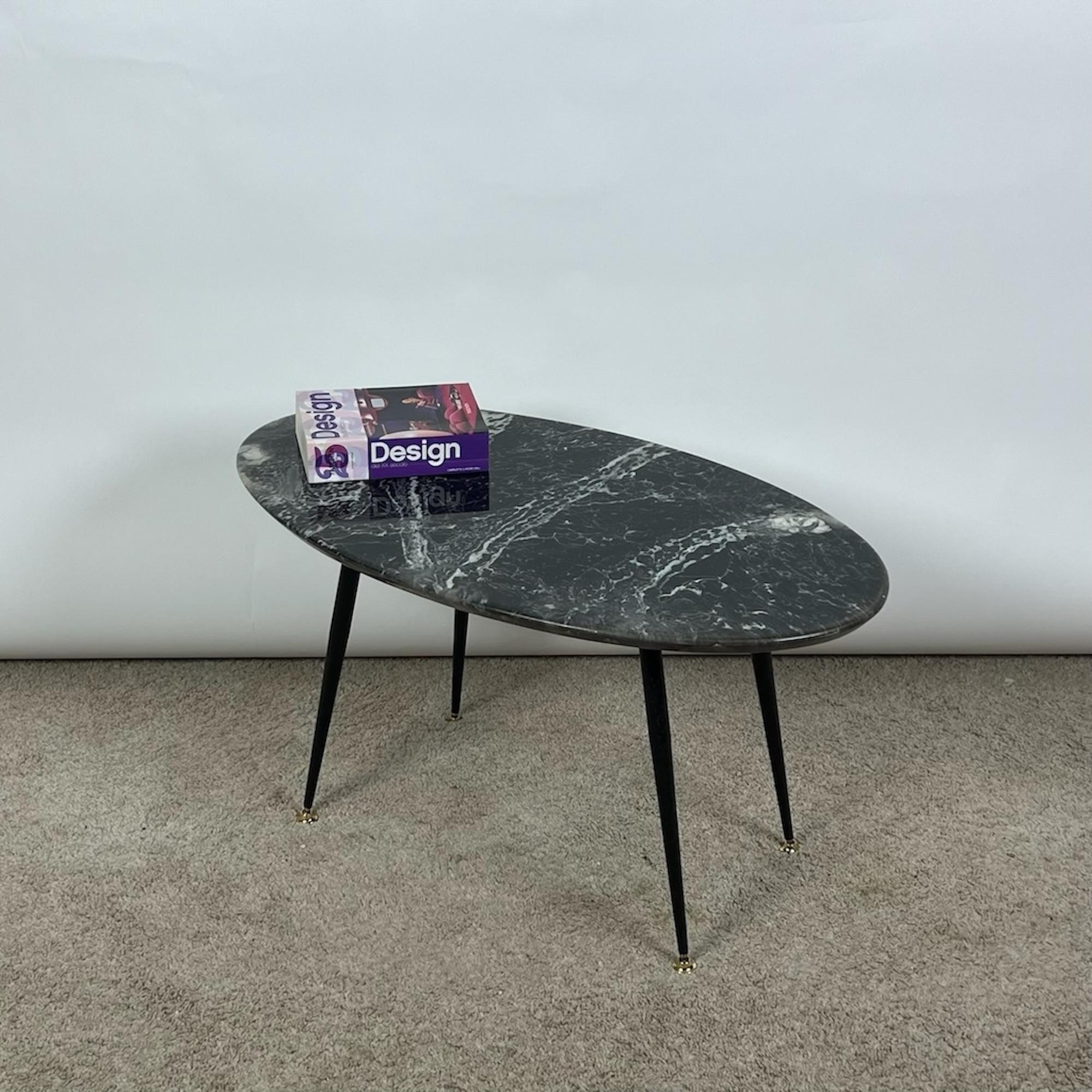 Transport yourself back to the early 1960s with this exquisite Italian vintage coffee table, a timeless piece that exudes vintage elegance and versatility. Crafted with meticulous attention to detail, this lovely low table features an oval faux