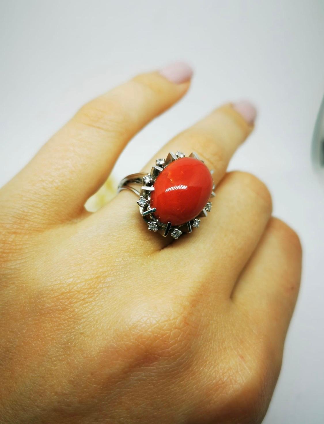 Vintage Coral and Diamonds ring

This amazing white gold ring with coral cabochon measures 18 millimeters by 13 millimeters.
The beautifully cut elongated oval coral cabochon is embellishments by a gallery of 10 diamonds set at an angle to show off