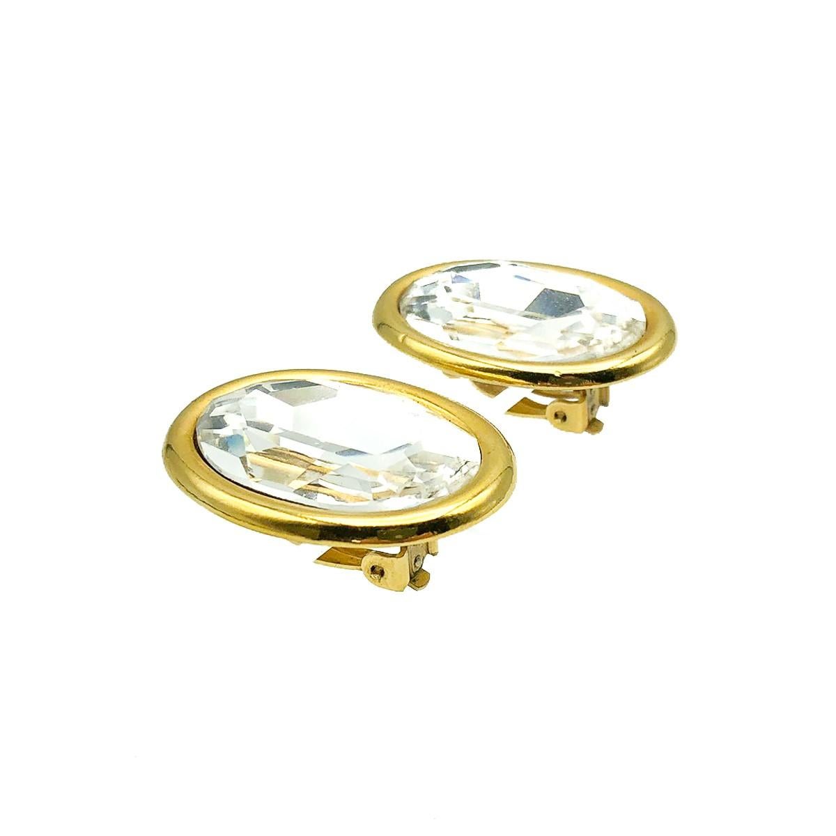 A superb pair of oversized vintage oval headlamp earrings. Featuring a stunning glass oval crystal set within a simple galleried gold rim setting for a beautiful contrast and finish. 
Condition: Very good without damage or noteworthy wear.