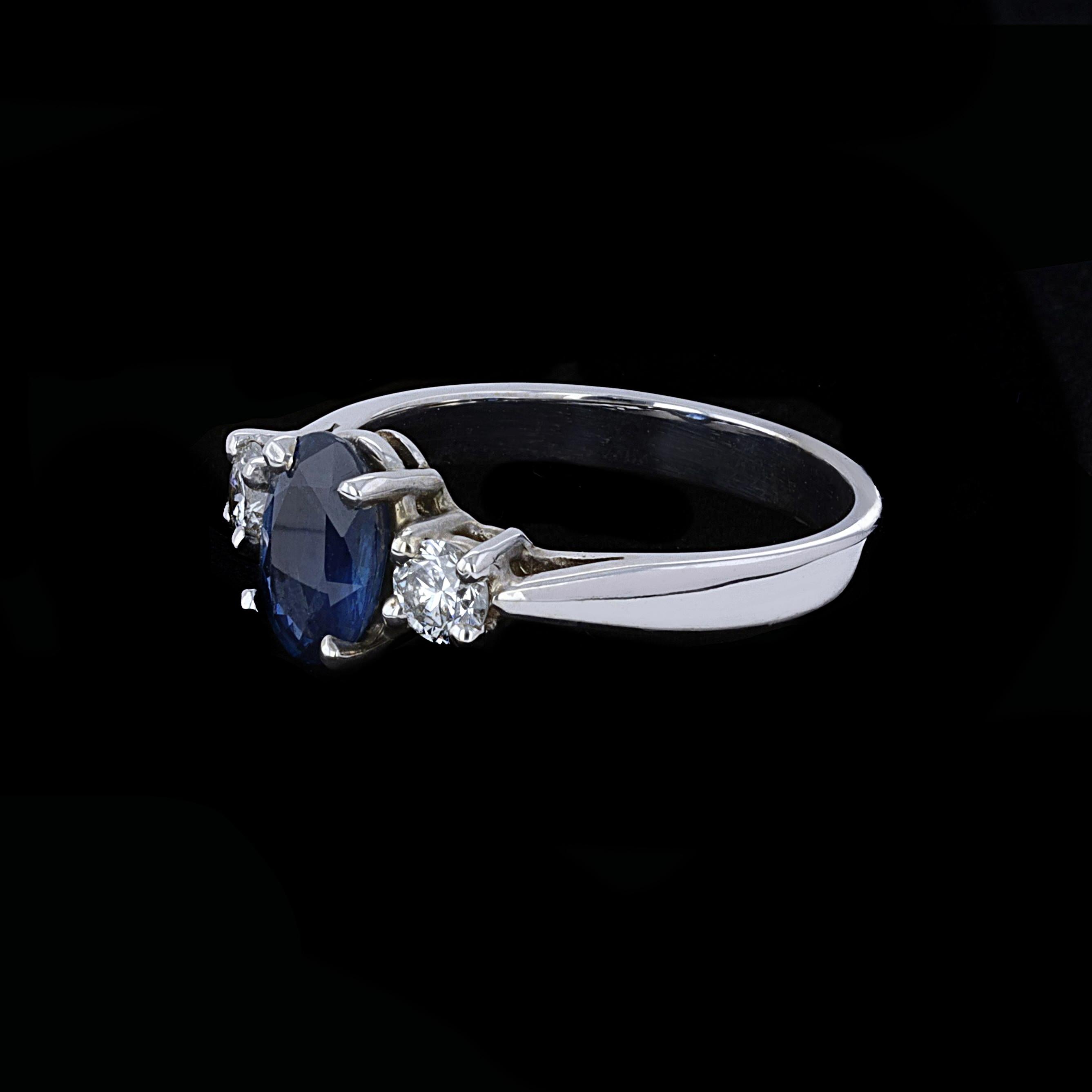 This spectacular three-stone ring is centered with an oval cut sapphire that weighs approximately 2.00ct. The sapphire is accentuated by round cut diamonds that weigh approximately 0.30ct. The color of the diamonds is H with VS clarity. The ring is