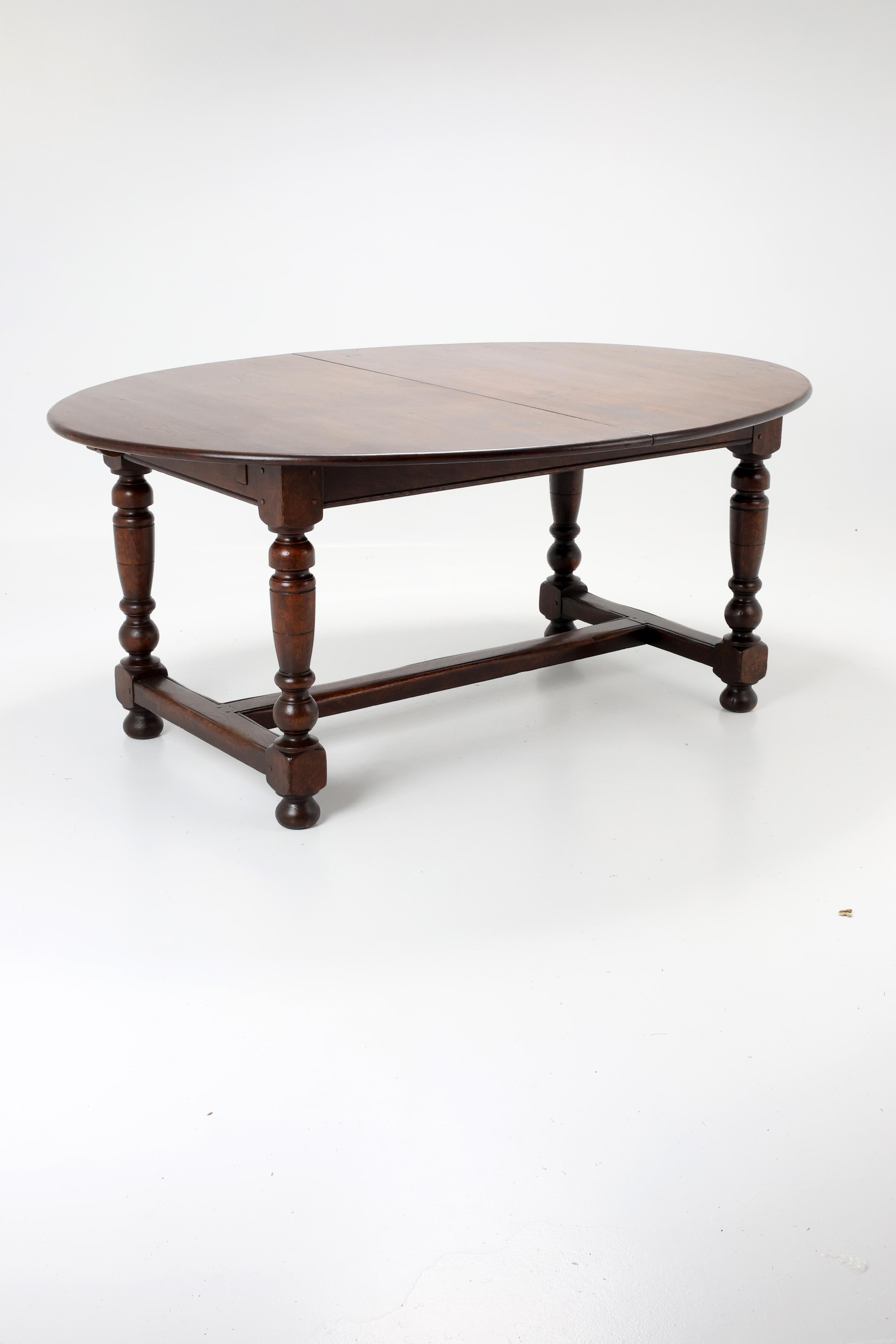 Vintage Oval Dining Table, Early 20th Century

A beautiful vintage extendable dining table crafted from solid oak wood, featuring an oval top with a central split and four turned legs connected by a sturdy stretcher base.
The table showcases elegant