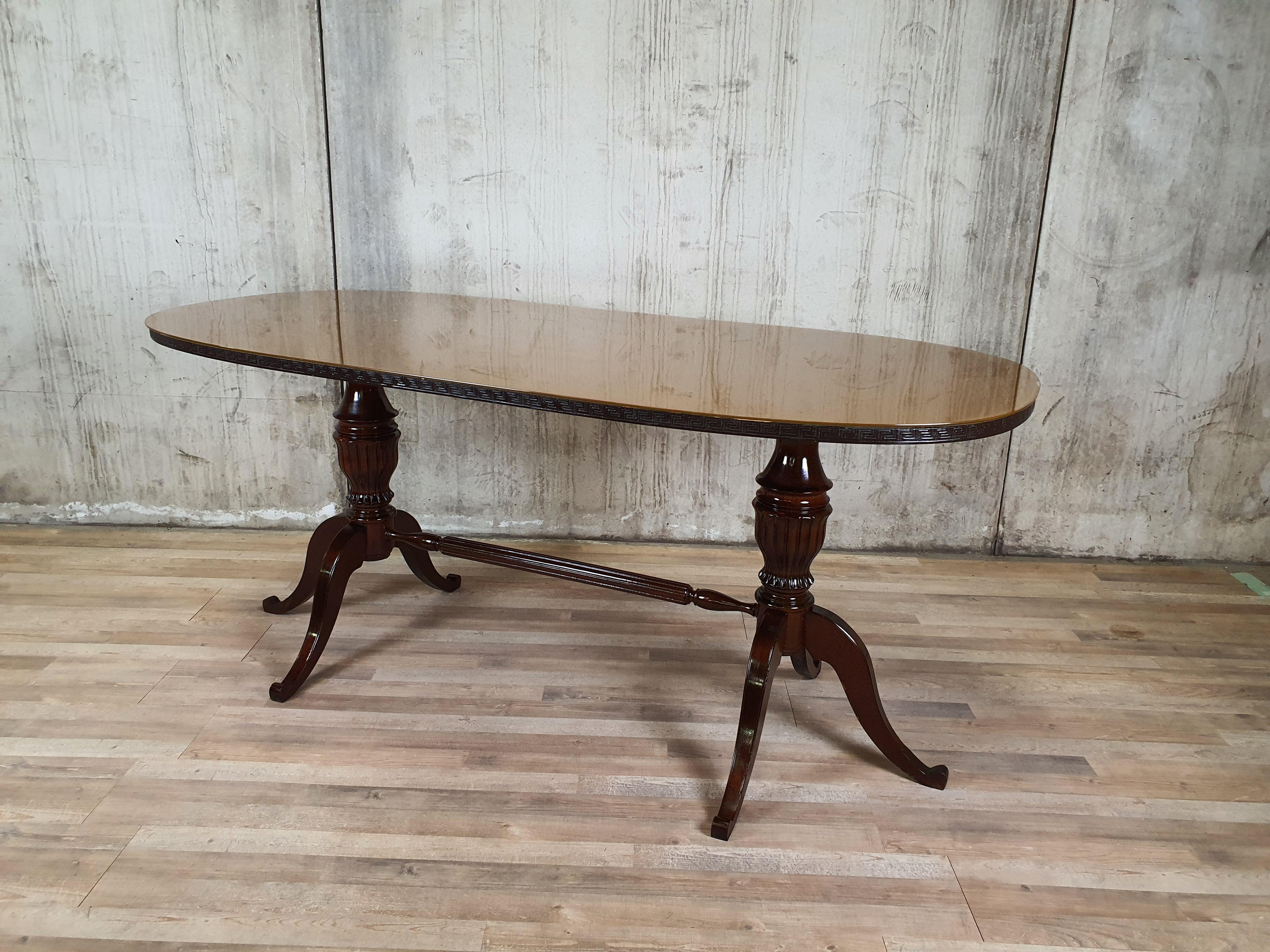 Elegant 1950s table with finishes along the edge and original glass top of the time.

The structure at the base of the table is very particular, entirely in worked and carved wood. It lends itself perfectly to modern or antique furnishings,