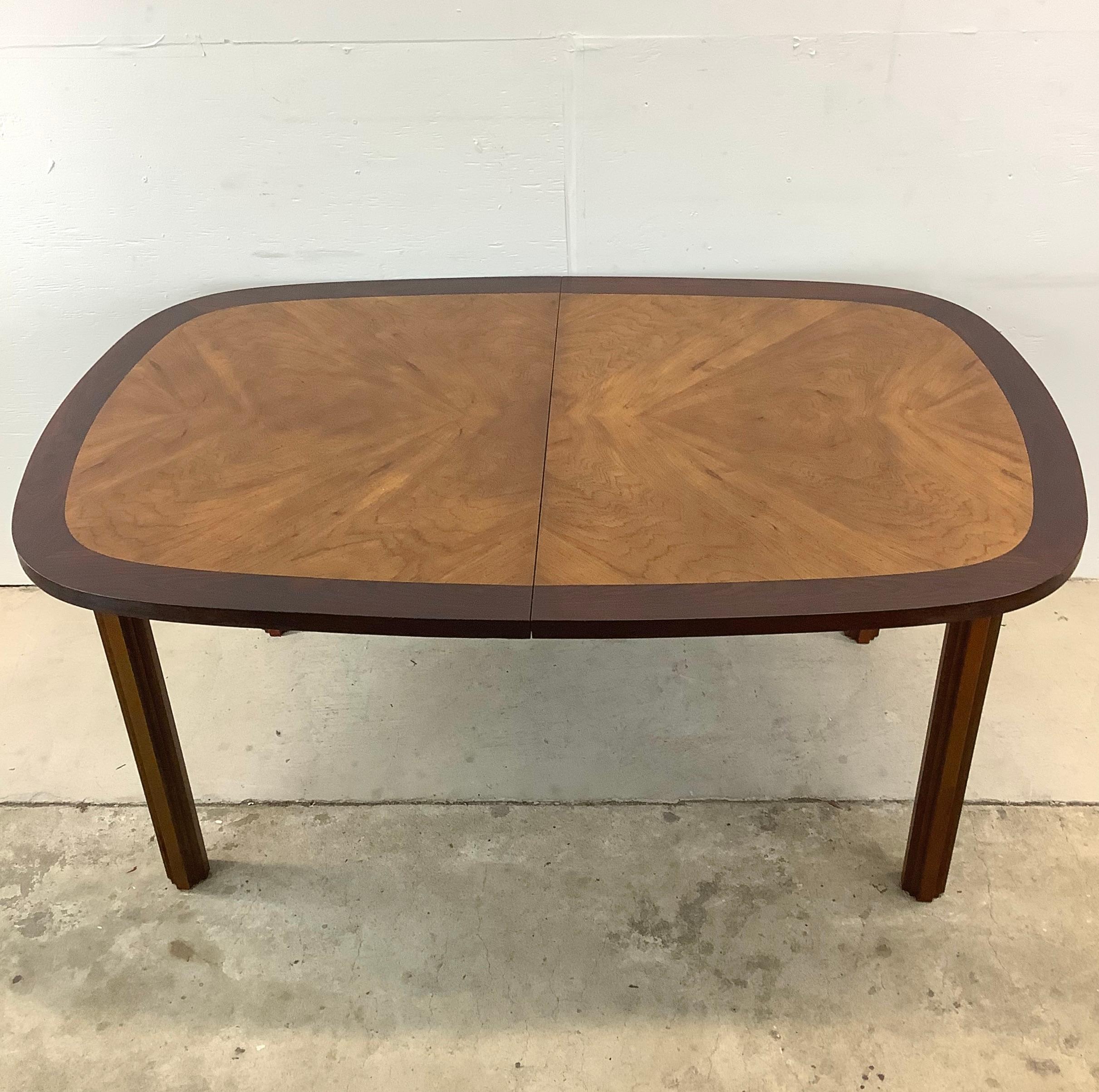 Step into a world of timeless elegance with this multi-tone Mid-Century Walnut Oval Dining Table in the style of Lane's Tower Suite line. Crafted with meticulous attention to detail, this exquisite piece adds a unique centerpiece to any dining area,