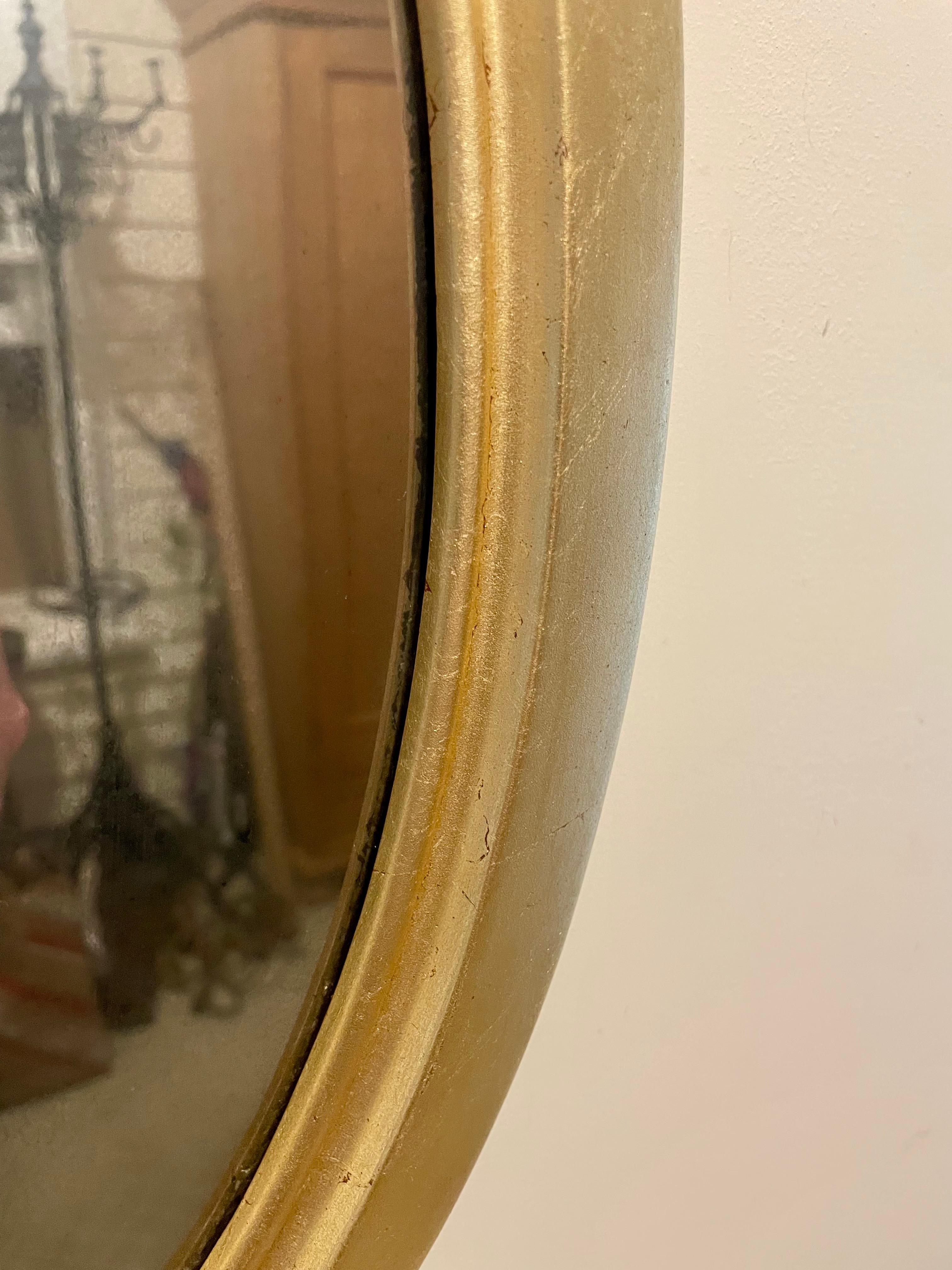 B. Altman and Company Giltwood oval mirror. Good overall vintage condition, Mirror is somewhat distressed and streaky from age and some wear to finish from age and use as shown in photos. Great size, Measures 19