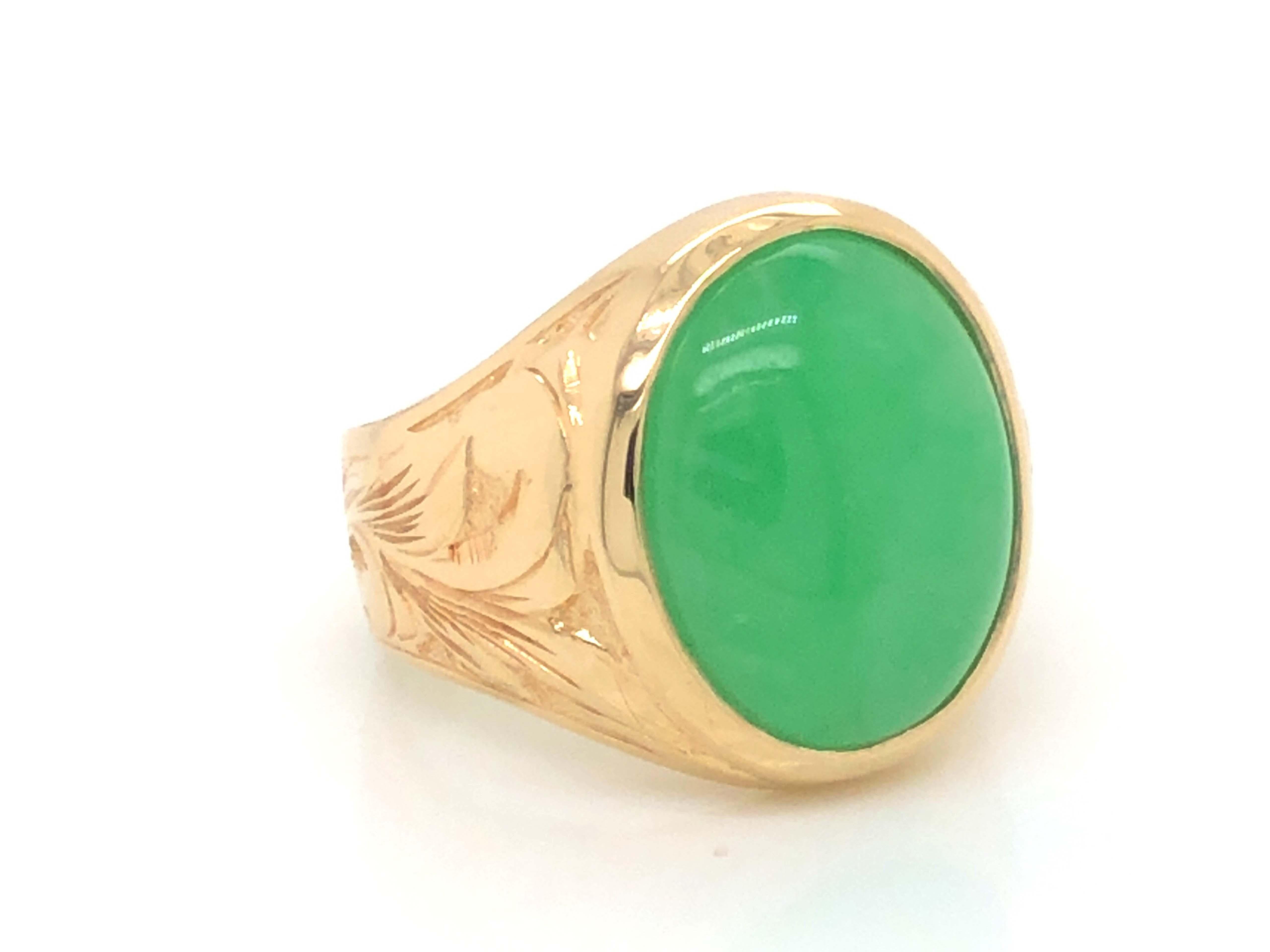 Magnificent vintage oval cabochon green jadeite jade ring, in 14k yellow gold. The beautiful apple green Jade is bezel set and measures approximately 15.89 mm x 13.02 mm x 5.30 mm. The ring has a tapered shank with a high polish finish and engraved