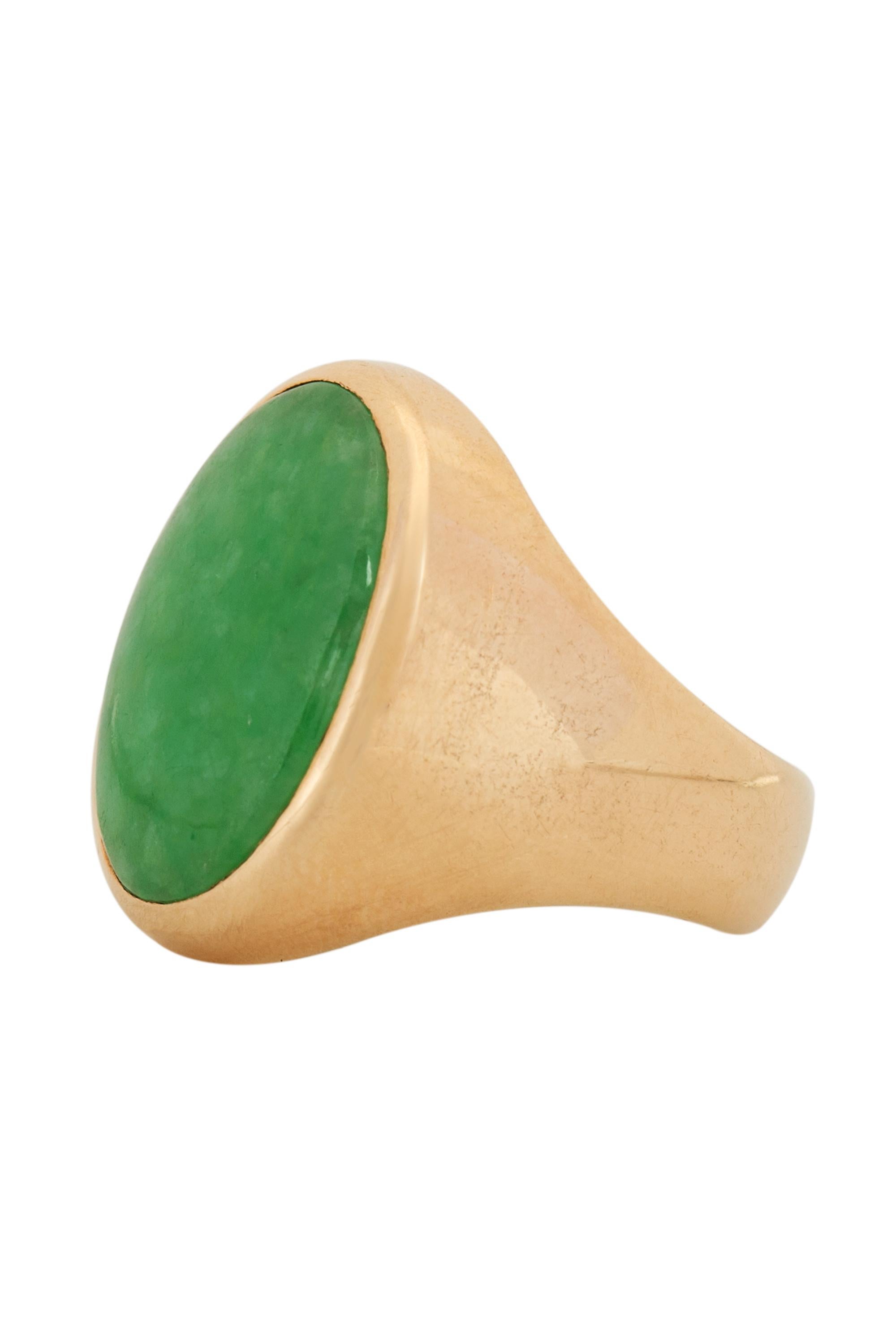 This discerning ring features a bright semi translucent oval of richly mottled green jadeite jade elegantly enhanced by a classic frame of 14 karat yellow gold. Current ring size 7 ½ and may be resized.