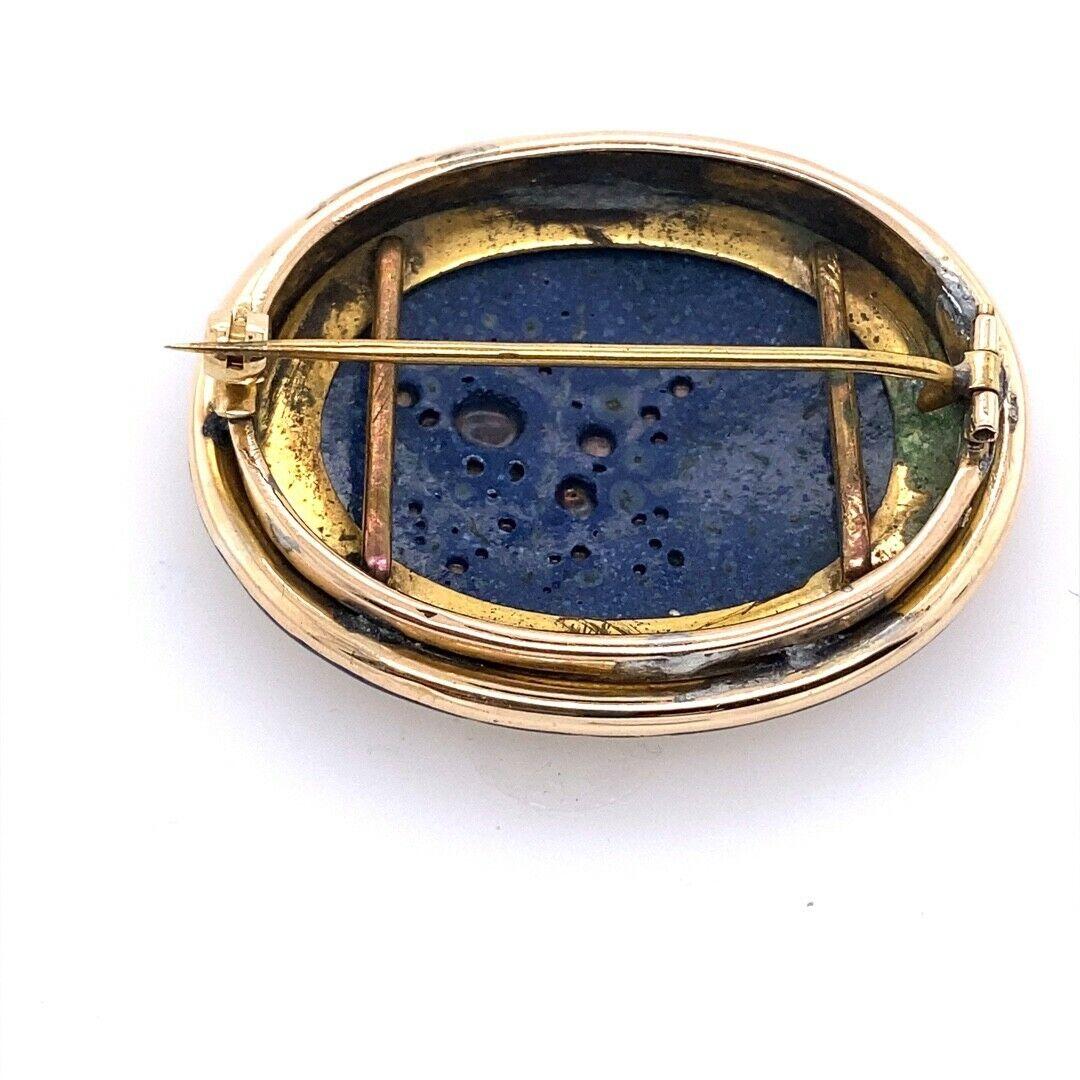 Vintage Oval Hand Painted Angels Scene, Set In 9ct&14ct Yellow Gold

With blue enamel brooch 44mm wide x 33mm deep with pin and roll catch fittings (Slight bit of pewter hidden under rim & rolled gold used as support for the scene on