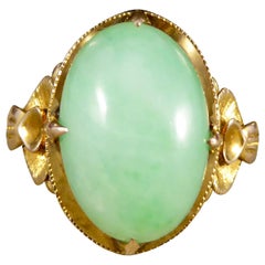 Vintage Oval Jade Ring in 14 Carat Yellow Gold with Decorative Shoulders