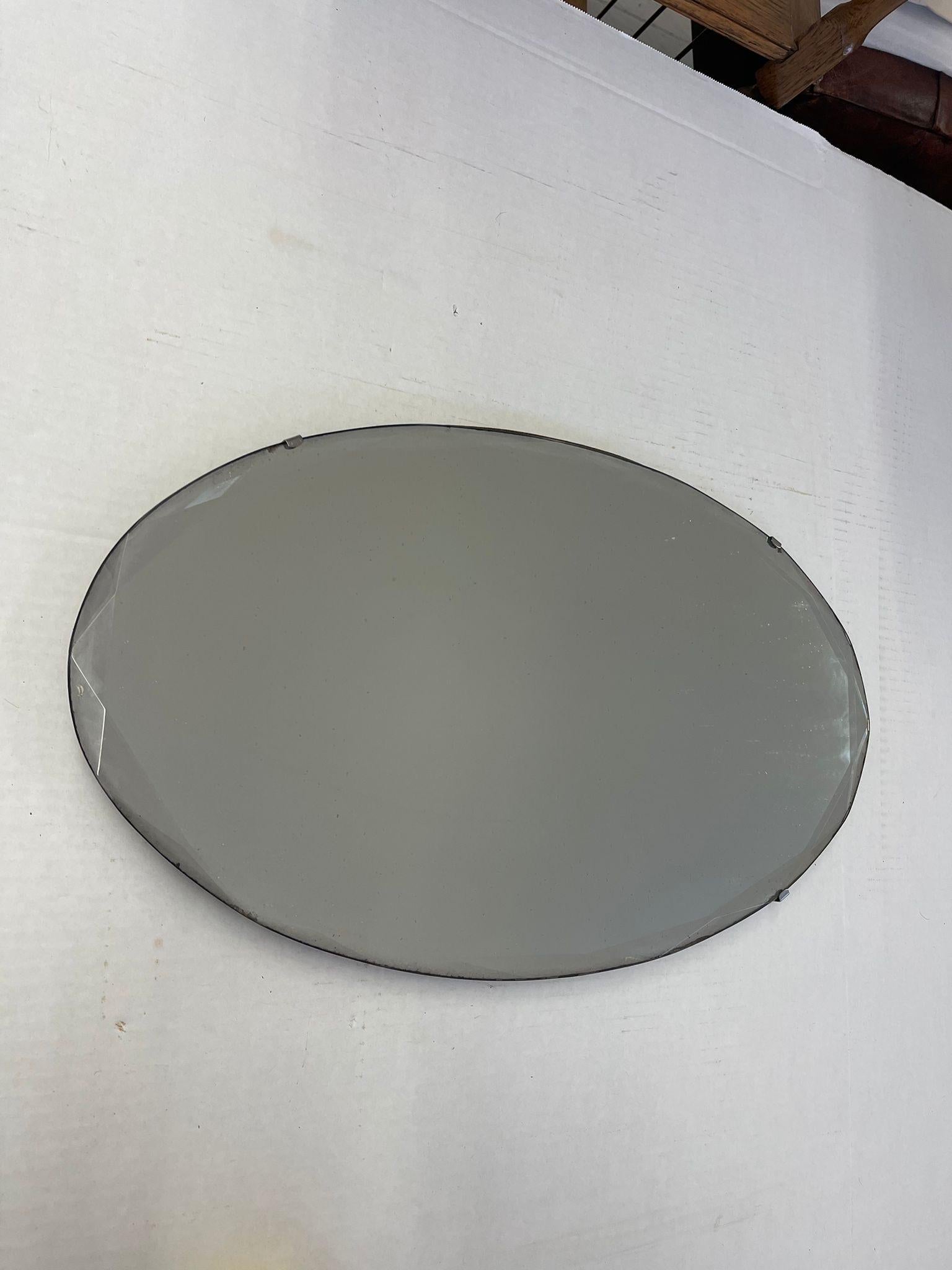 Gorgeous Oval Vintage Mirror that Catches Sunlight Beautifully. Petina Consistent with Age. Vintage Condition Consistent with Age as Pictured.

Dimensions. 22 W ; 13 H