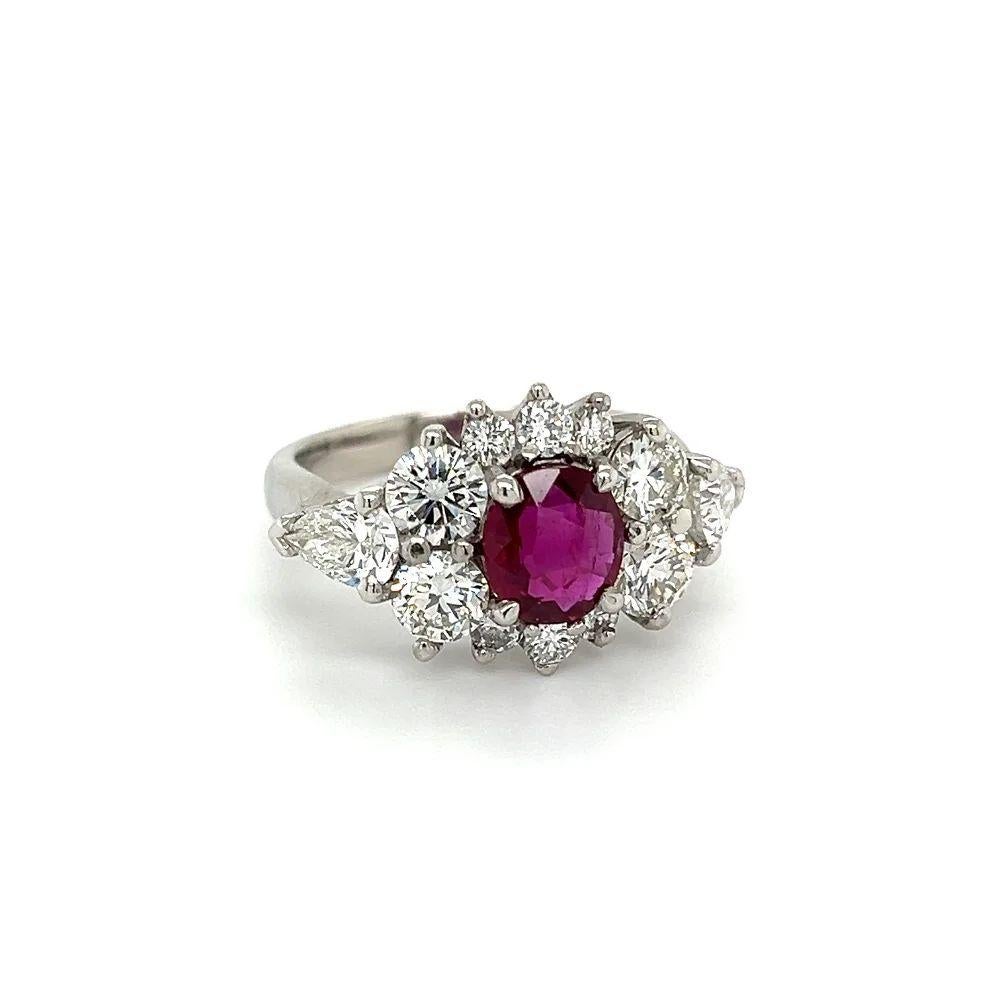 Simply Beautiful! Finely detailed NO HEAT Ruby GIA and RBC & Pear Diamond Ring. Centering a Gorgeous securely nestled Hand set GIA Oval NO HEAT RUBY, weighing approx. 1.53 Carat, GIA report number #5221986529. Surrounded by a Halo of Sparkling Round