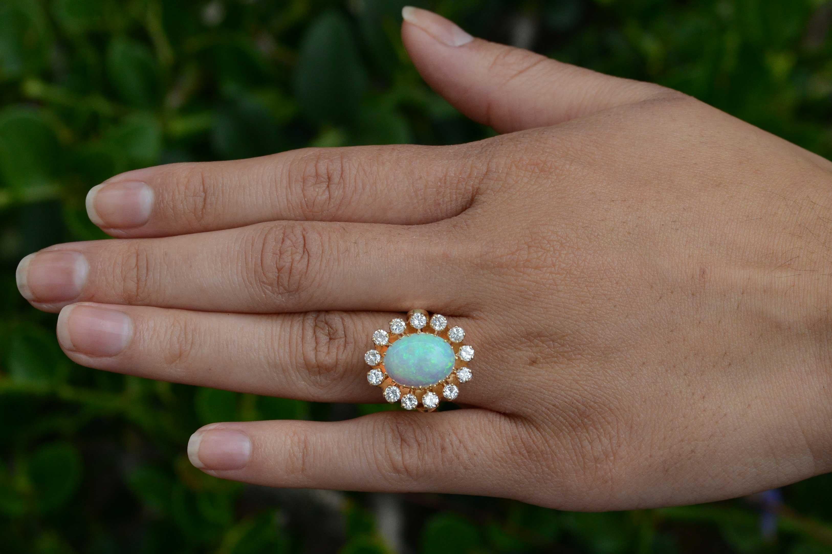 The Irving Vintage Cocktail Ring. A swoon-worthy statement cluster ring with a dynamic, gorgeous fiery, pinfire opal at it's heart. The sizable 3 carat gemstone glows with an inner fire, having a dynamic play-of-color, emitting rolling flashes of