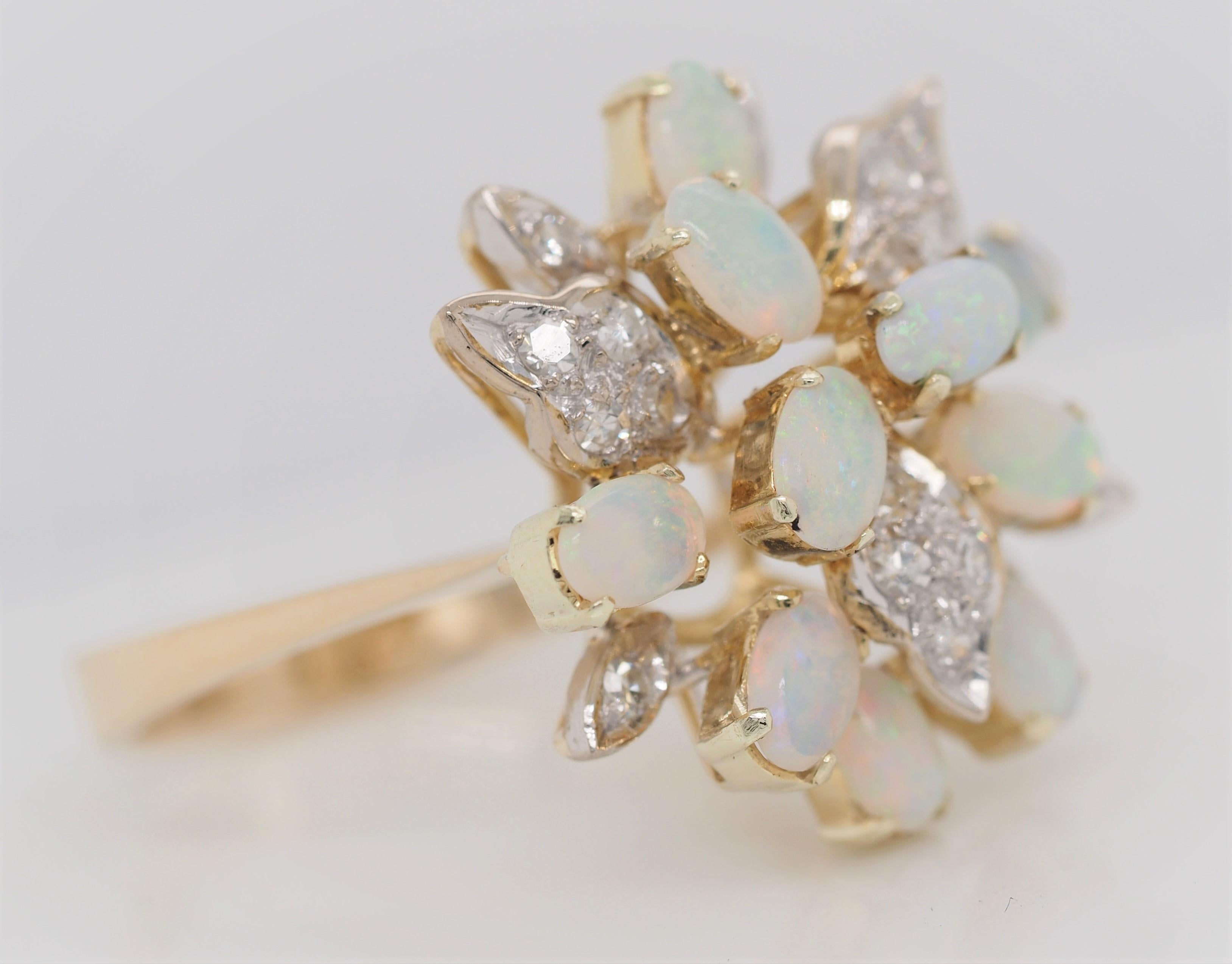 This genuine piece is crafted with a beautiful yellow gold band that has 10 round cut shimmering opals. There are 14 diamonds Single Cut Diamonds weighing 0.21 ct, G in color, SI1-SI2 in clarity. This ring gives a fantastic color play, displaying