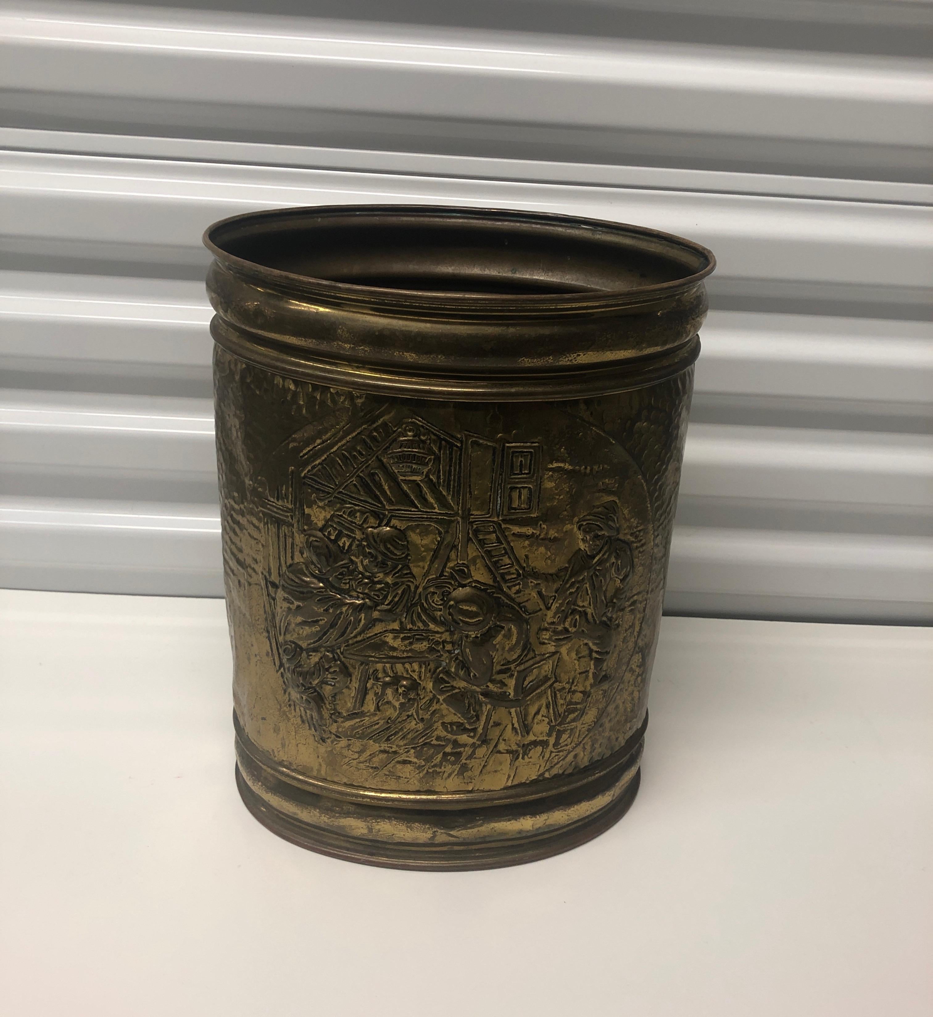 Vintage oval polished brass repousse wastebasket
with campaign scene, oval shape.
Size: 13.5” H x 7” D x 10” W.