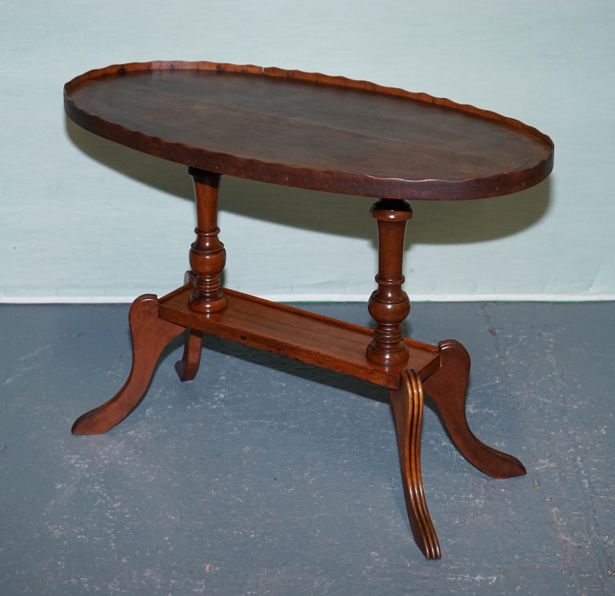 
Antiques of London



Gracefully proportioned and rich with historic charm, this 19th‑century oval tilt‑top occasional table pairs elegant form with versatile function. Its finely grained mahogany top, defined by a delicately scalloped gallery